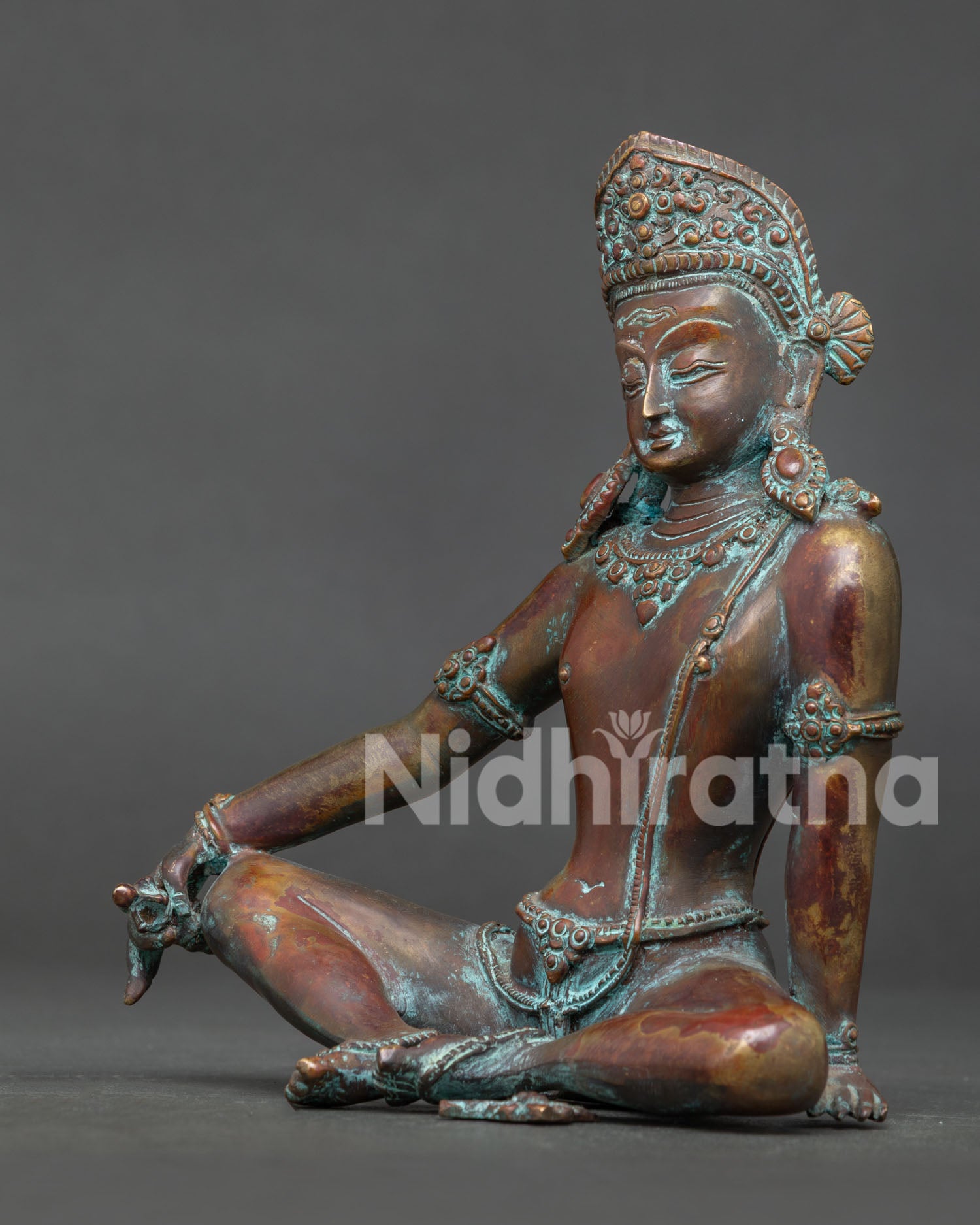 Indra statue side view showing seated posture jewelry and antique oxidized copper finish.