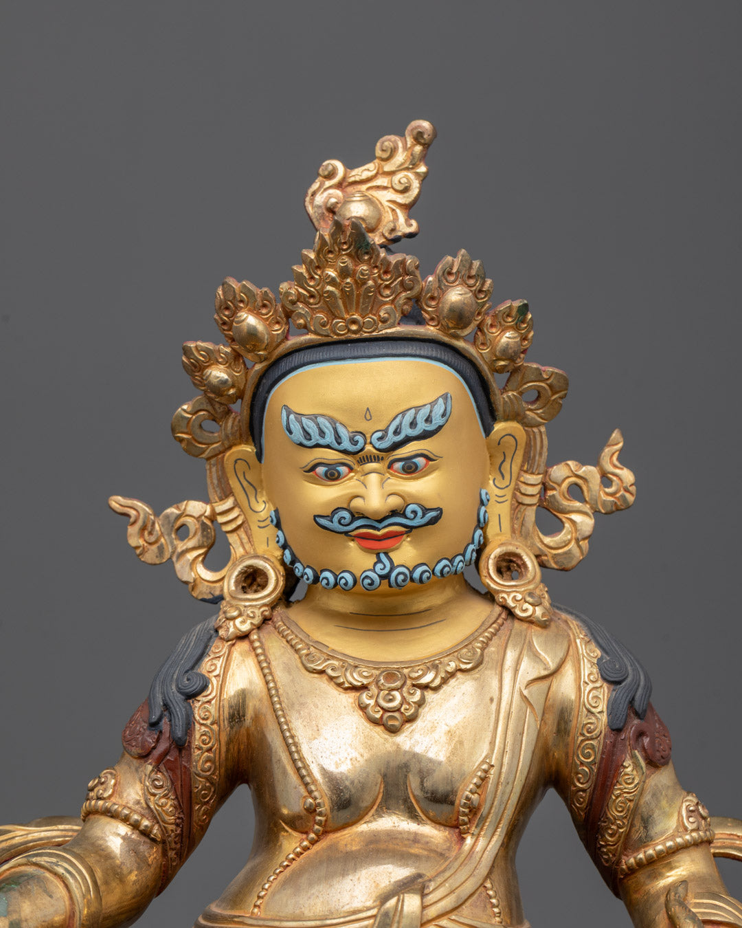 intricate gold-gilded Jambhala Kubera face - wealth deity, detailed jewelry & carvings