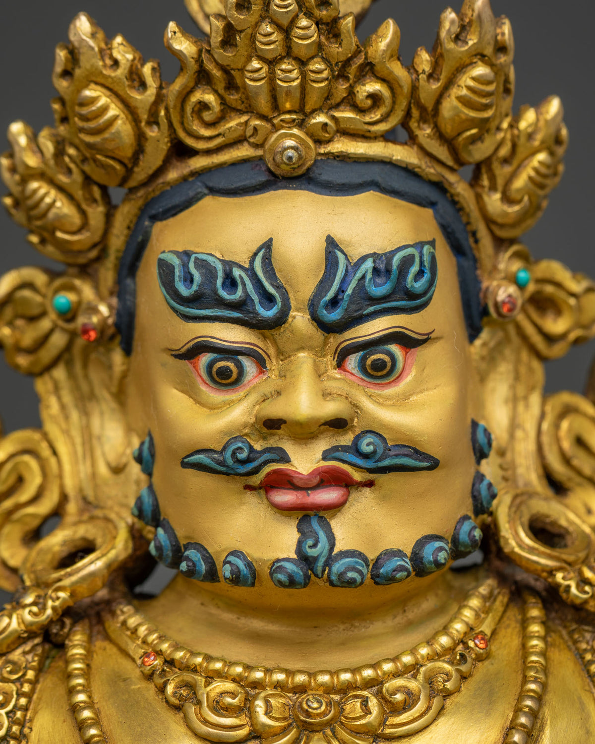 Jambhala Buddha face detail, handcrafted Wealth God with gold fire-gilding and turquoise markings