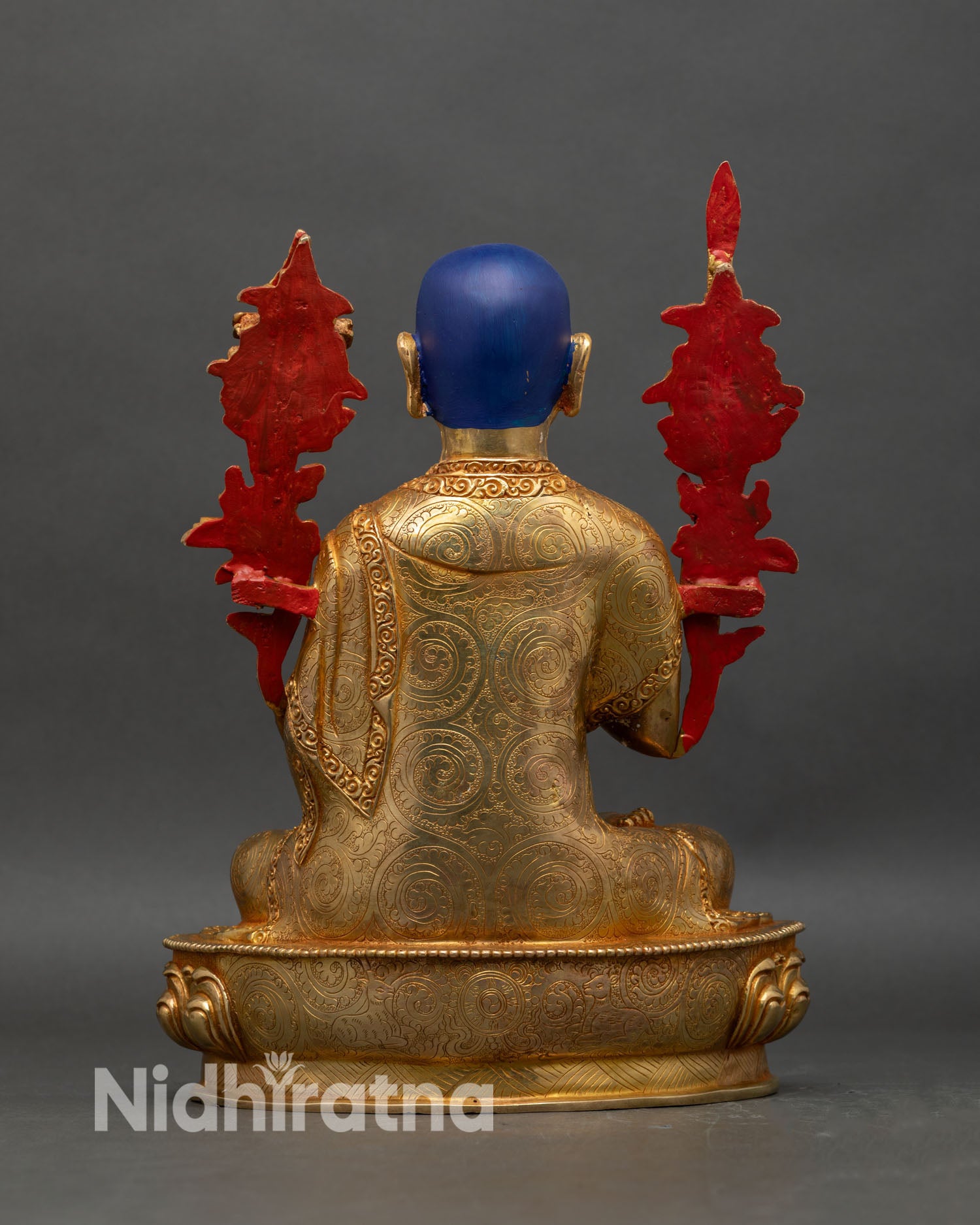 Back view of Je Tsongkhapa statue showing robe folds and lotus throne base