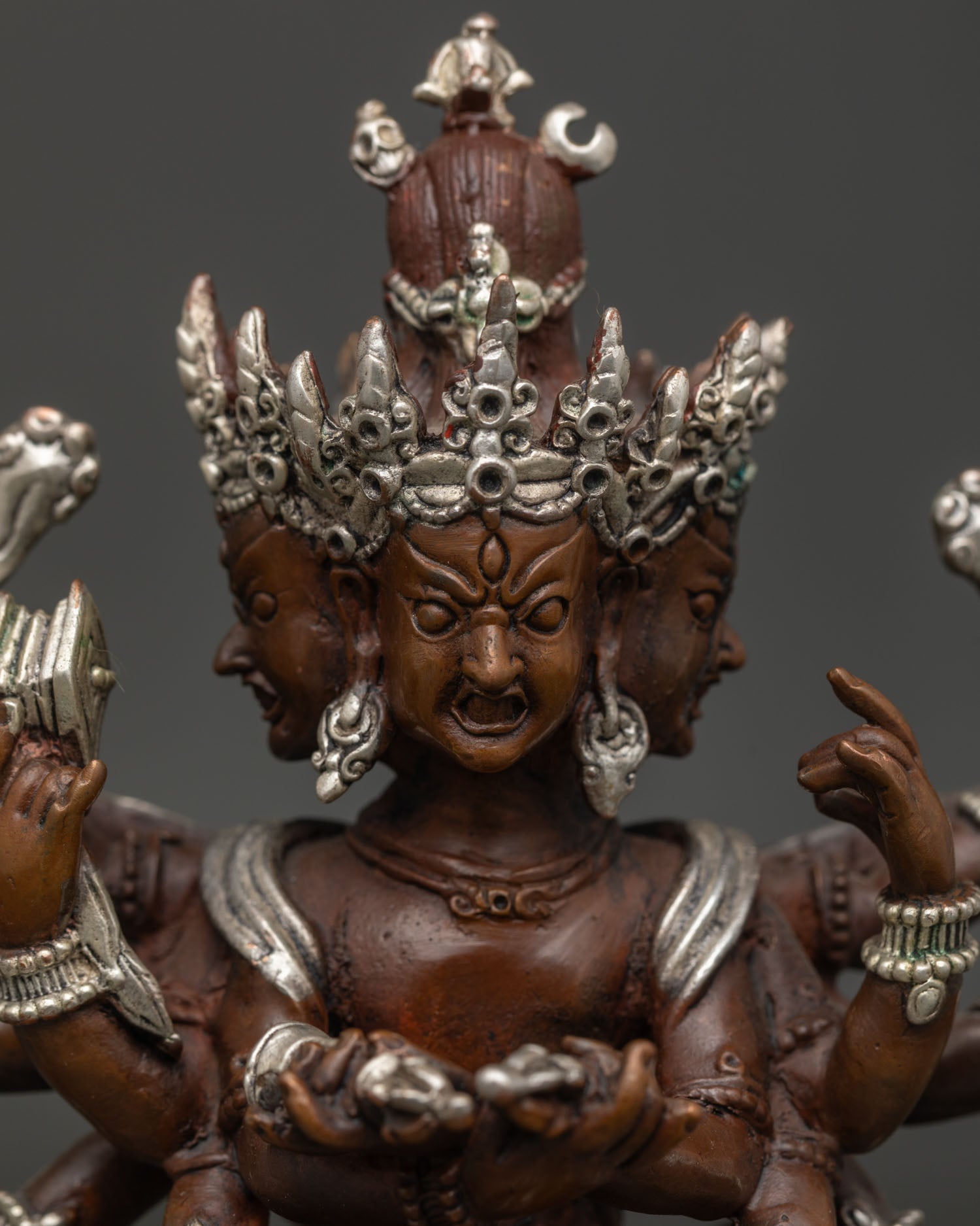 Kalachakra statue showing sacred ritual implements and oxidized copper.