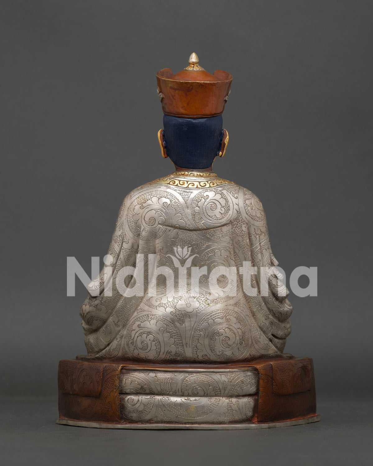 Karmapa statue highlighting gold painted face crown and intricate Nepalese details.