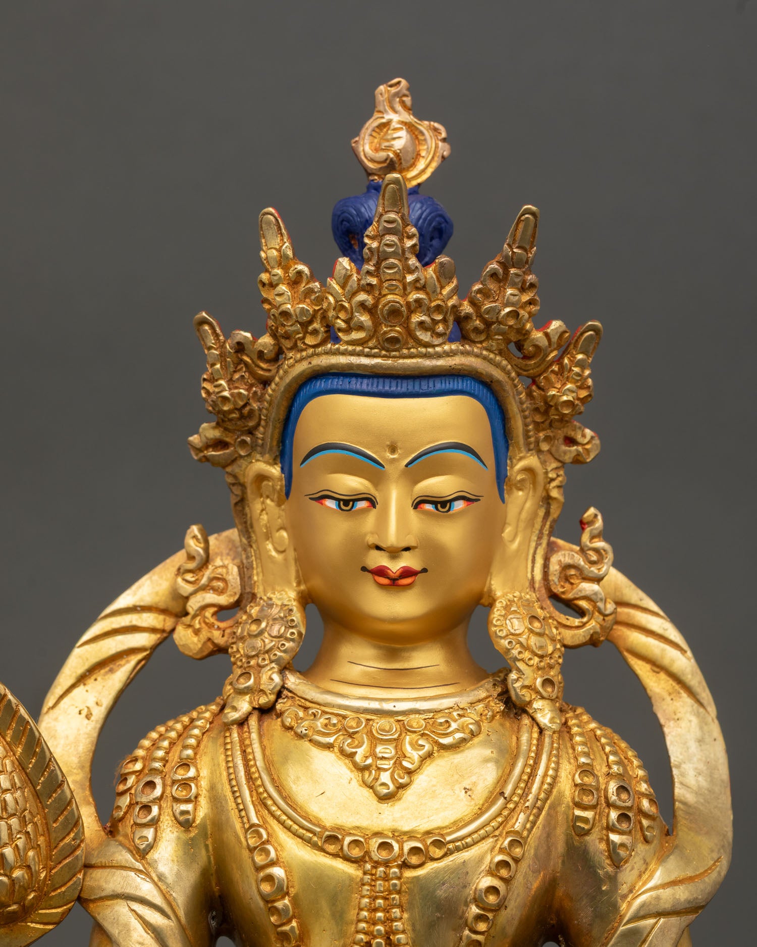 Kshitigarbha bodhisattva close up gold gilded face wish fulfilling jewel sacred Buddhist deity turquoise stone inlay detail Nepal art
