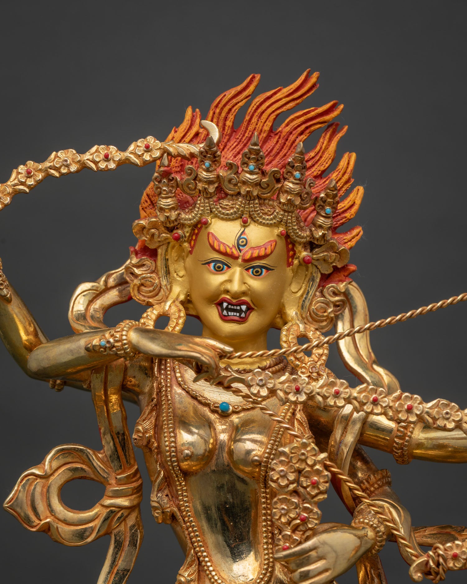 Kurukulla statue detailed 24K gold painted face semiprecious stones.