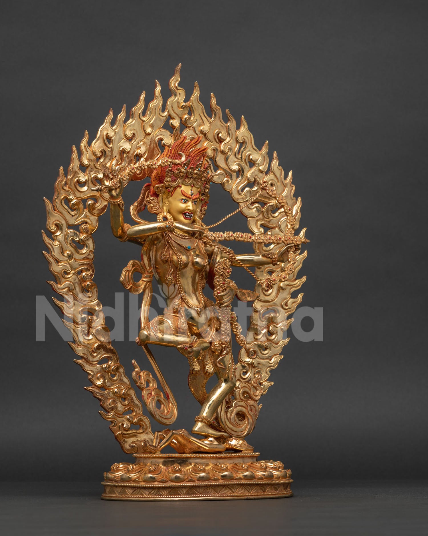 Kurukulla statue four arms bow arrow hook noose flaming halo.