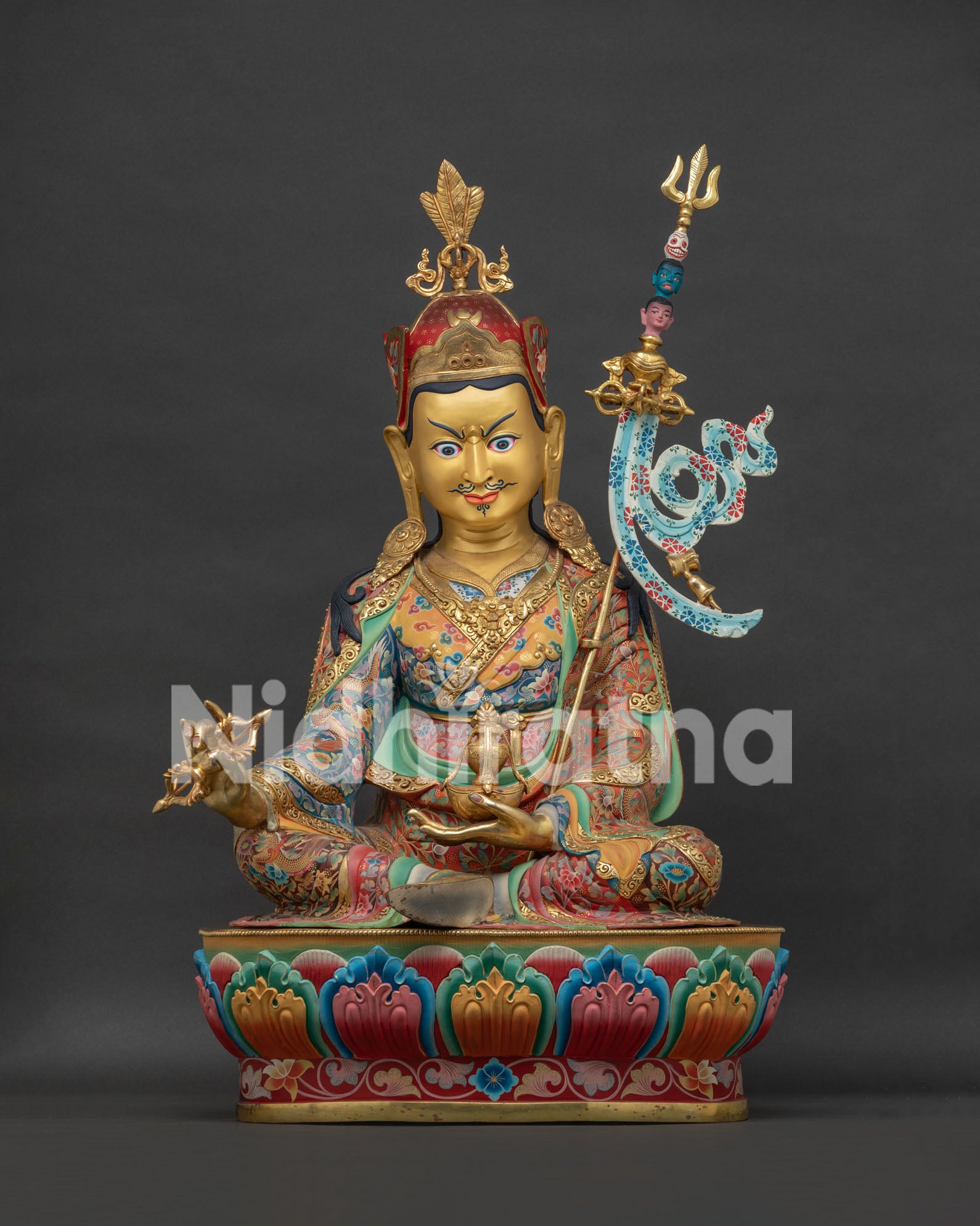Large Guru Rinpoche Padmasambhava statue front view with radiant gilding and colorful lotus throne