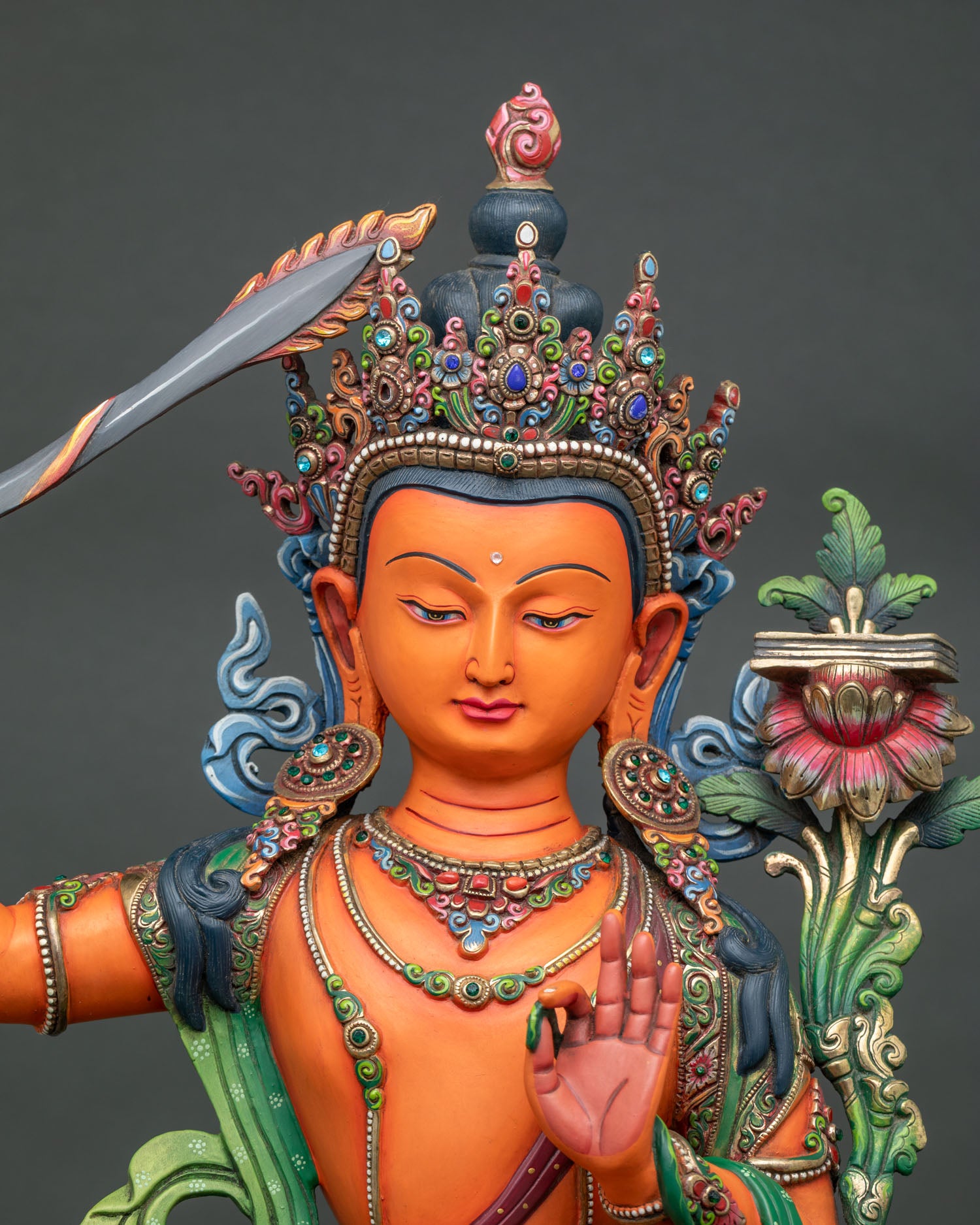 Large Manjushri statue close up with gold gilding and hand painted details