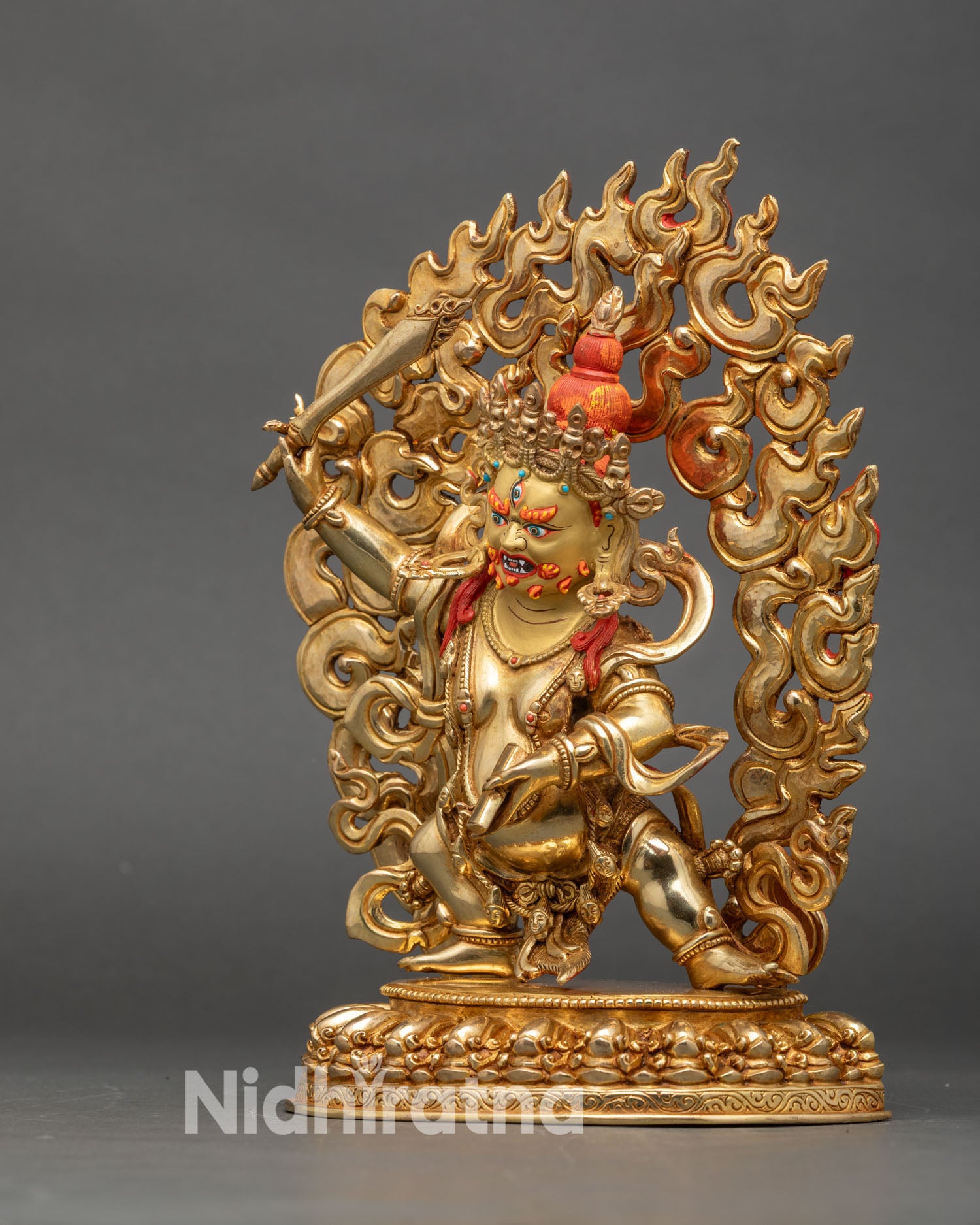 Left profile of Black Manjushri statue, adorned with coral and turquoise gemstones