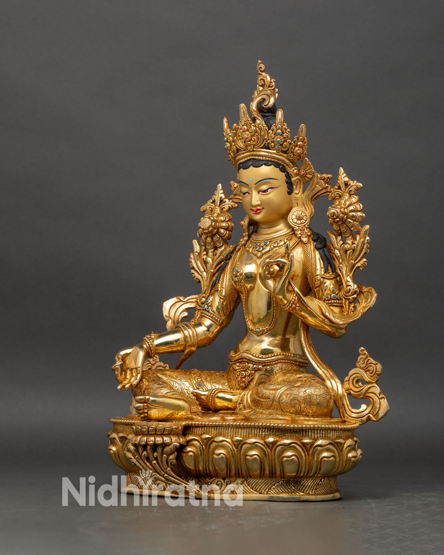 Left profile of Green Tara statue showing flowing robes and detailed craftsmanship