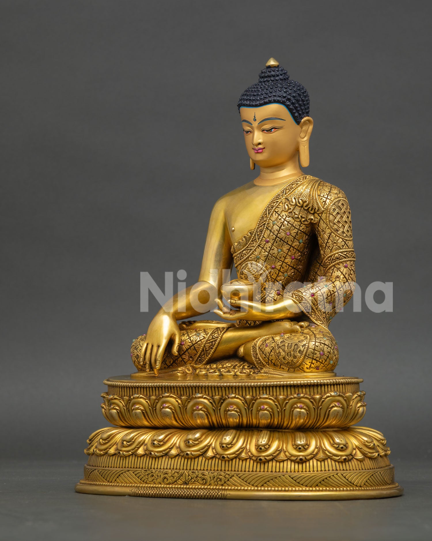 Left profile of Shakyamuni Buddha statue featuring fire-gilded gold finish and Himalayan Buddhist art