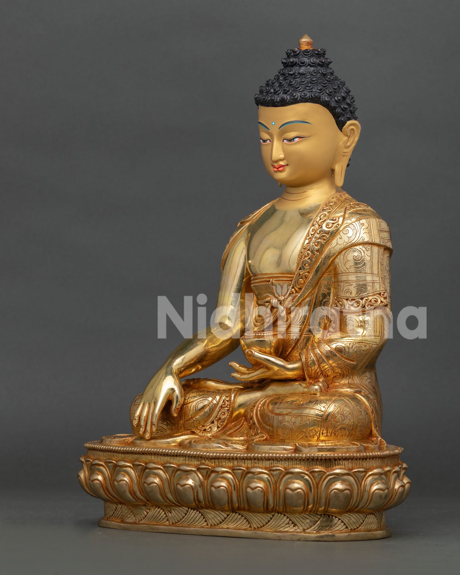 left profile of shakyamuni buddha statue with traditional nepalese gilded artistry