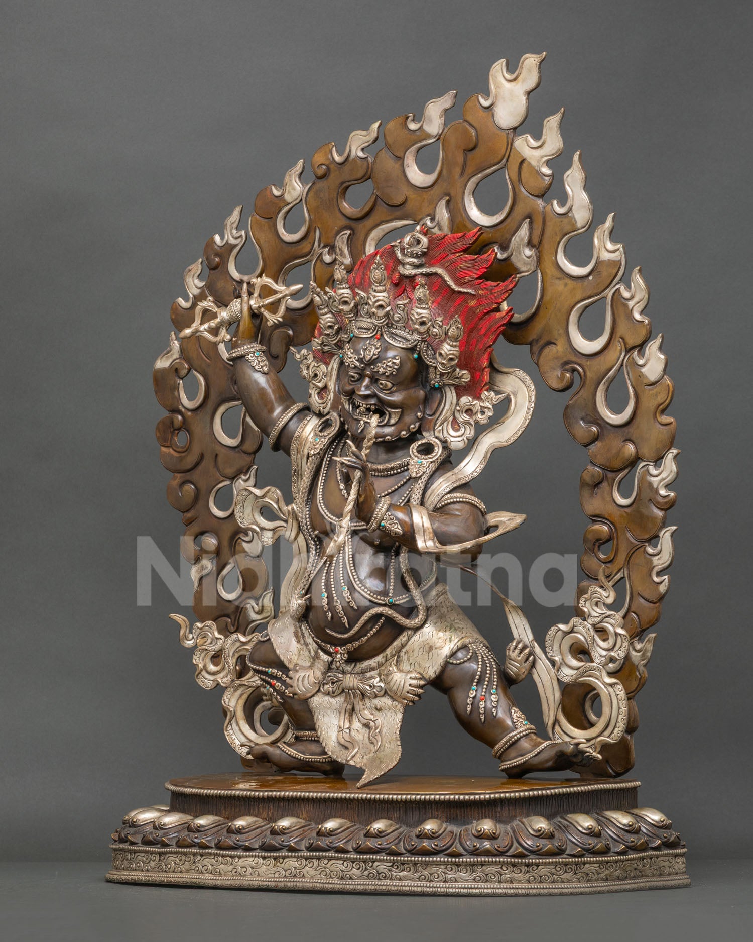 left profile of Vajrapani sculpture showcasing flowing ornaments dynamic stance and oxidized finish