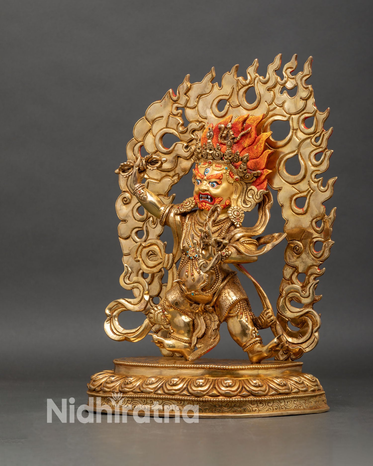 Left profile of Vajrapani statue showing flowing scarves and ornate lotus pedestal