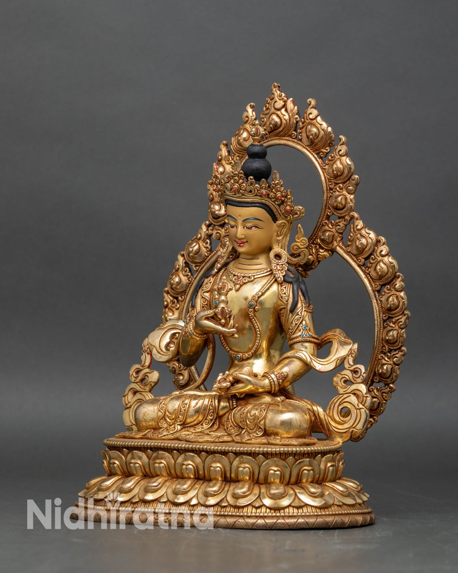Left profile of Vajrasattva statue with gold gilding and sacred Vajrayana details