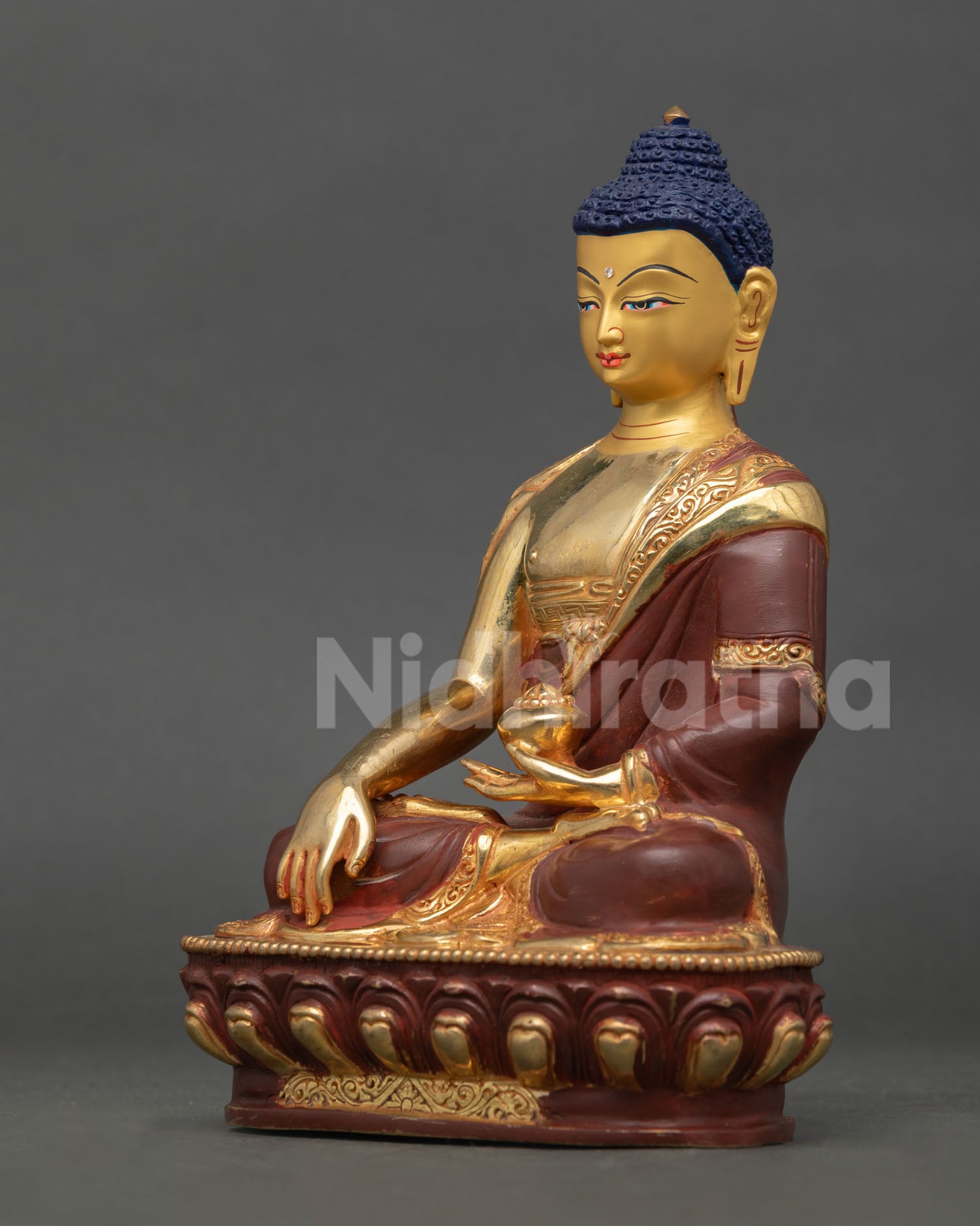 Left profile view of Shakyamuni Buddha statue, traditional Himalayan Buddhist art with refined metalwork