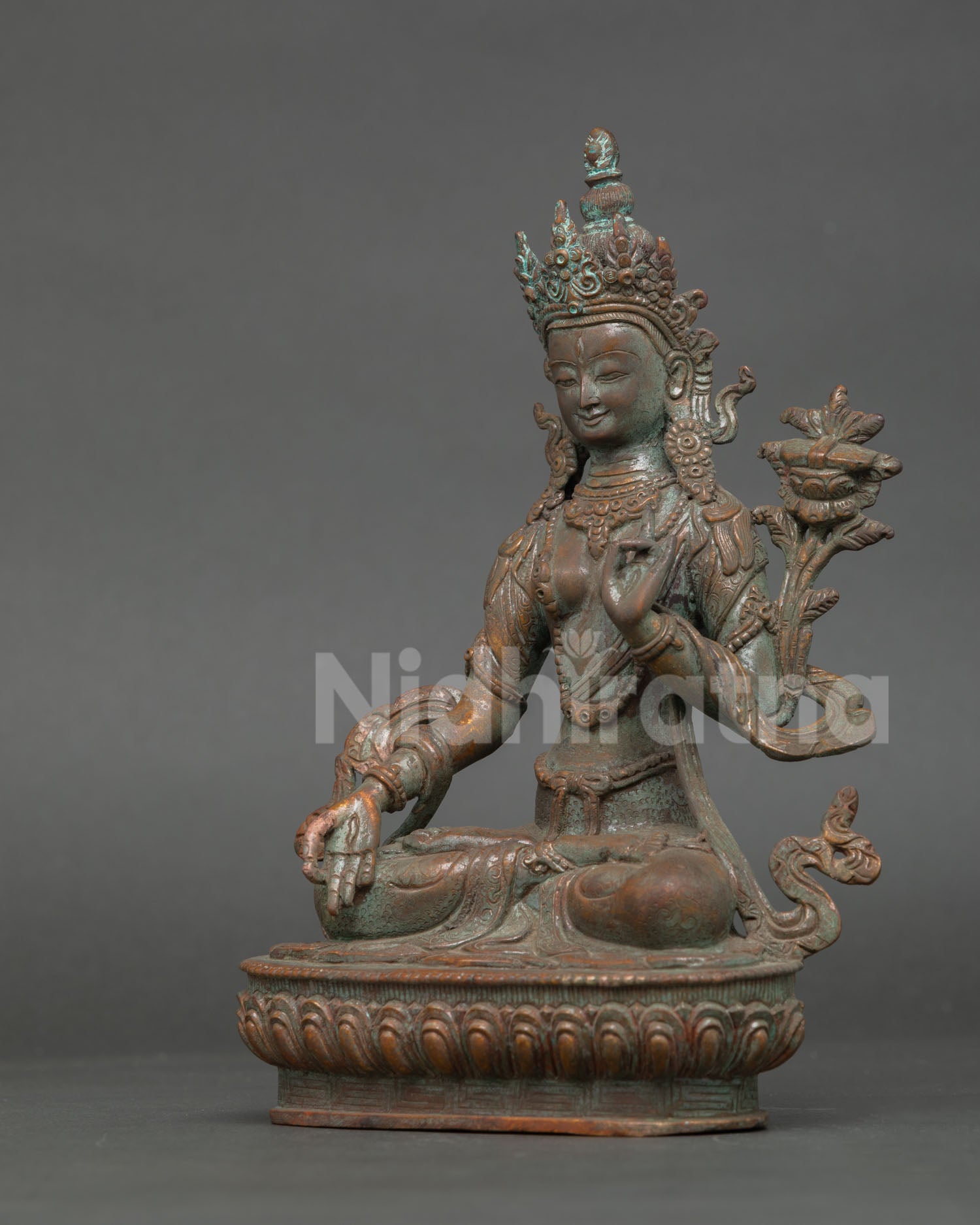 left side profile of white tara goddess statue with oxidized finish and traditional ornaments