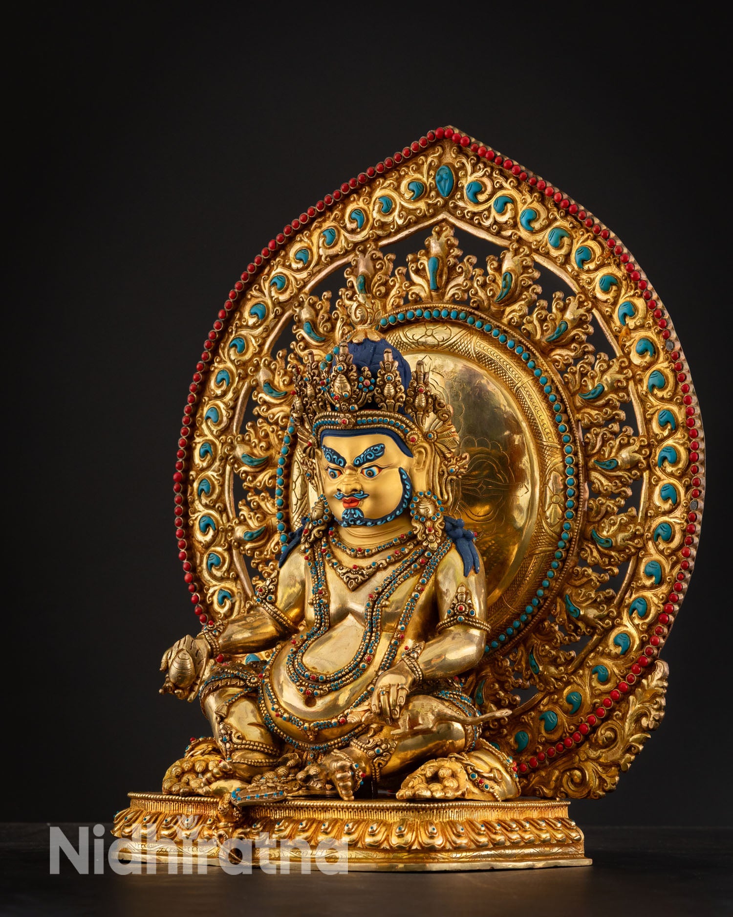 Left side view of Dzambhala statue fire gilded copper Kathmandu Nepal handcrafted Newari art