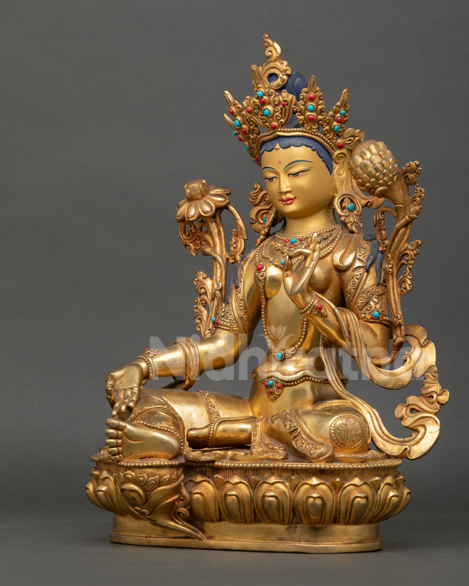 left side view green tara statue revealing robe detailing and traditional metal work finish