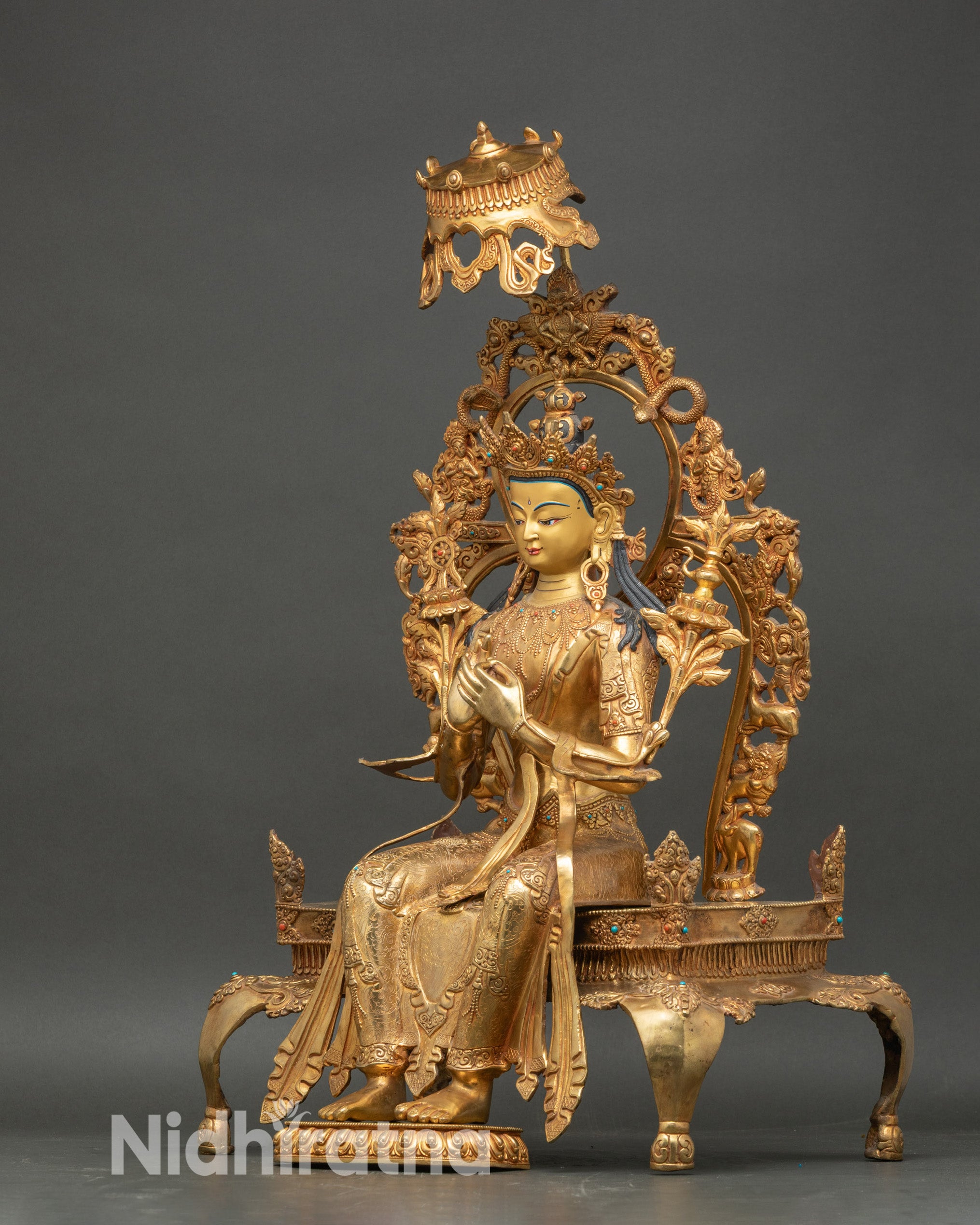 left side view of maitreya buddha statue, seated form and halo design
