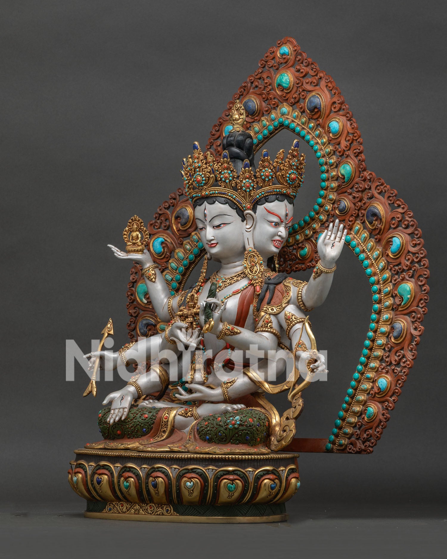 left side view of acrylic painted namgyalma statue with floral halo and gold gilded details
