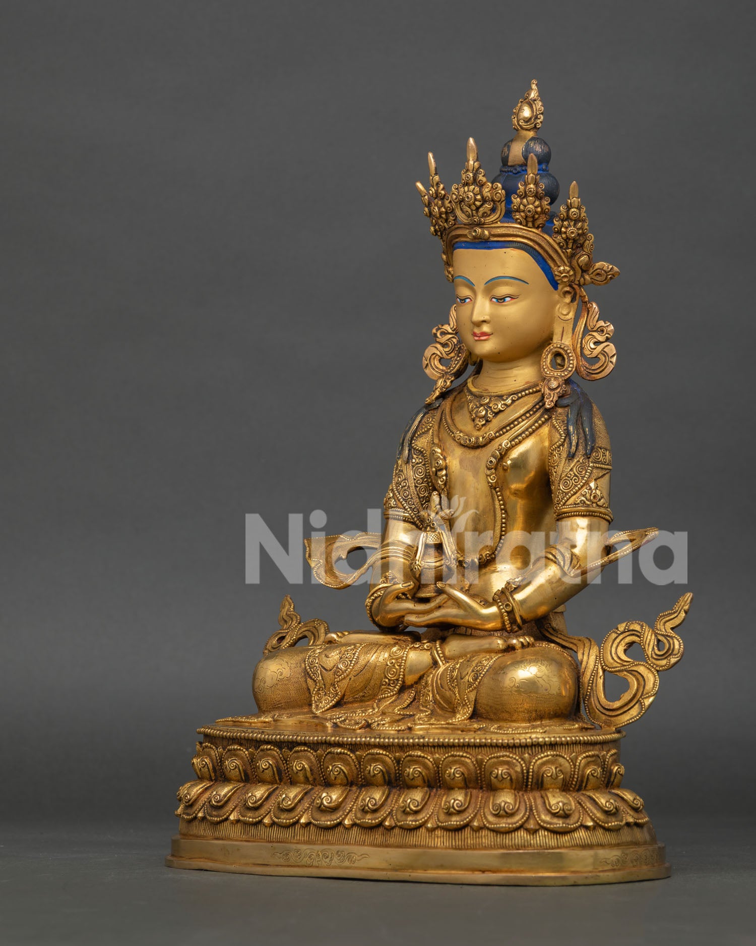 left side view of amitayus buddhist sculpture with copper and gold gilded details