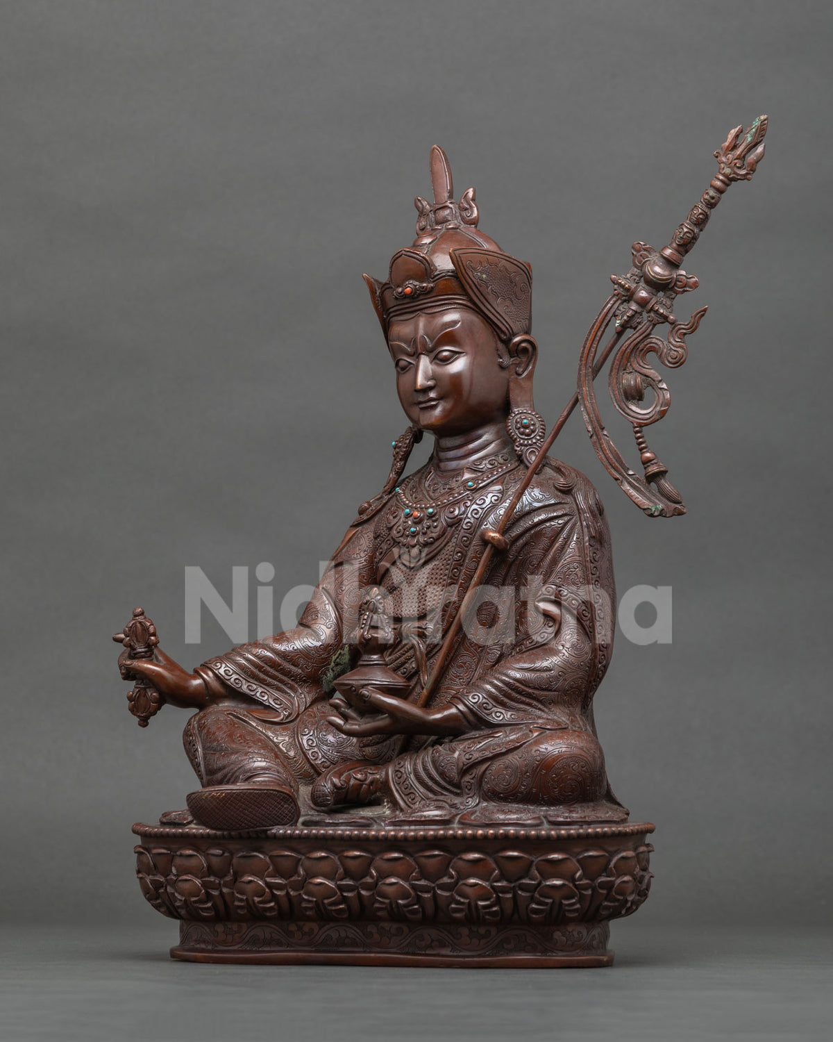 Left side view of brown oxidized copper Padmasambhava statue, handcrafted Buddhist art from Nepal