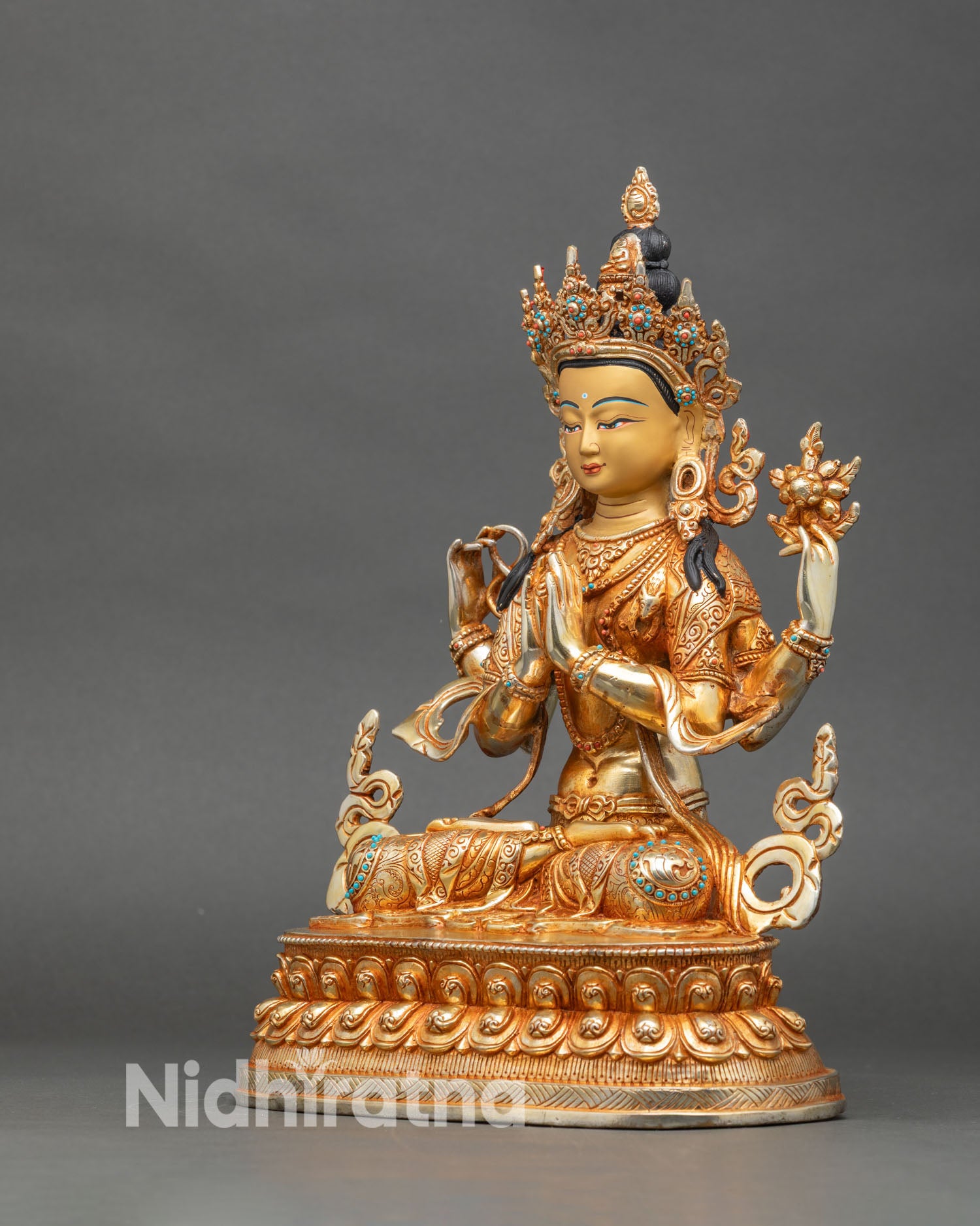 left-side-view-of-chenrezig-statue-fire-gilded-copper-detailed-robes-sacred-attributes