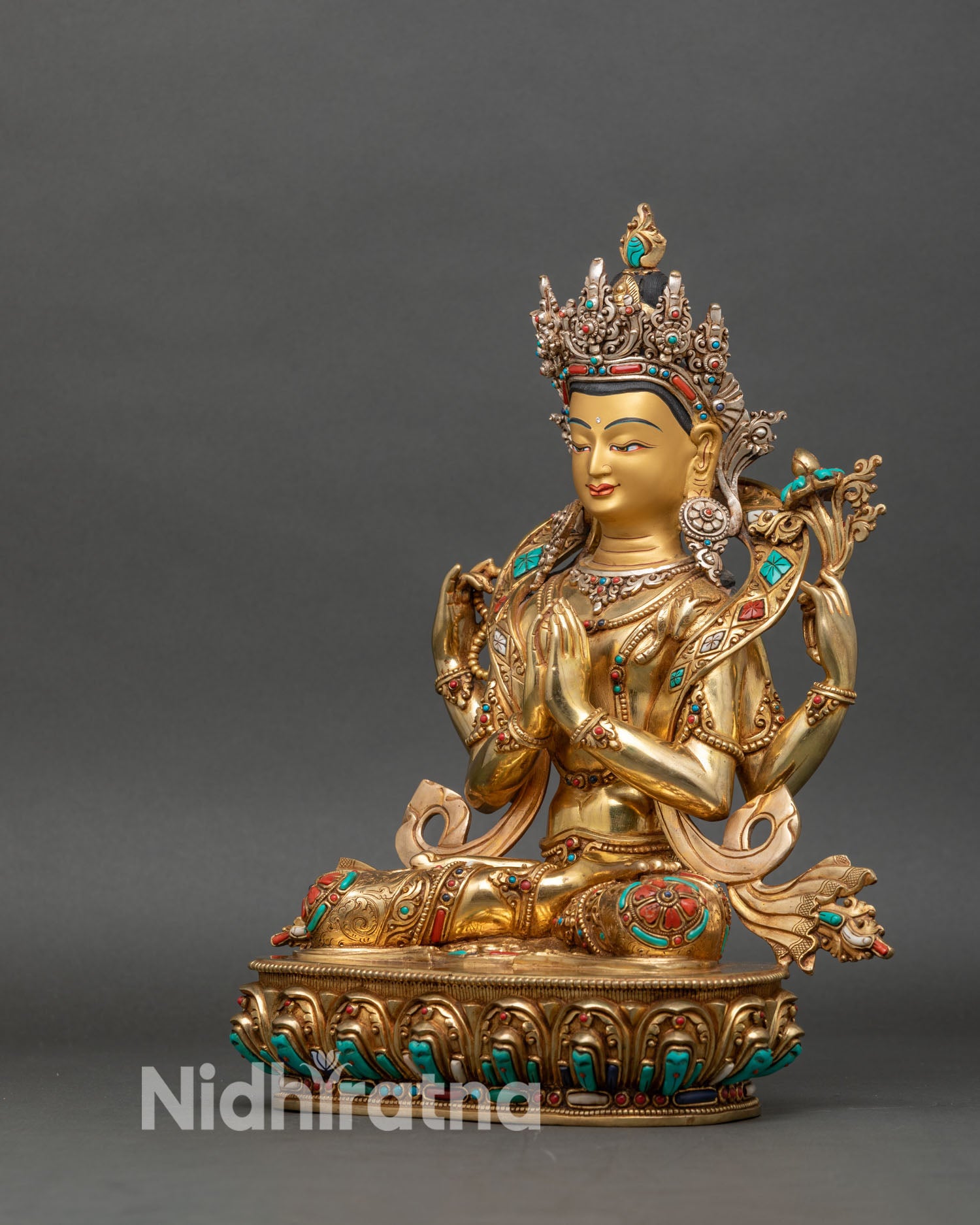 Left side view of Chenrezig Statue, four-armed Bodhisattva holding sacred items