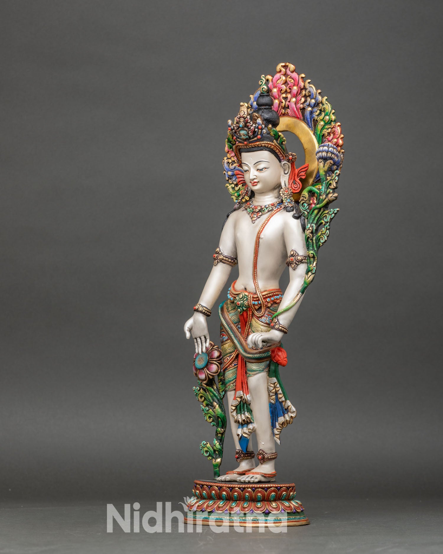 left side view of chenrezig statue showing intricate jewelry and lotus pedestal