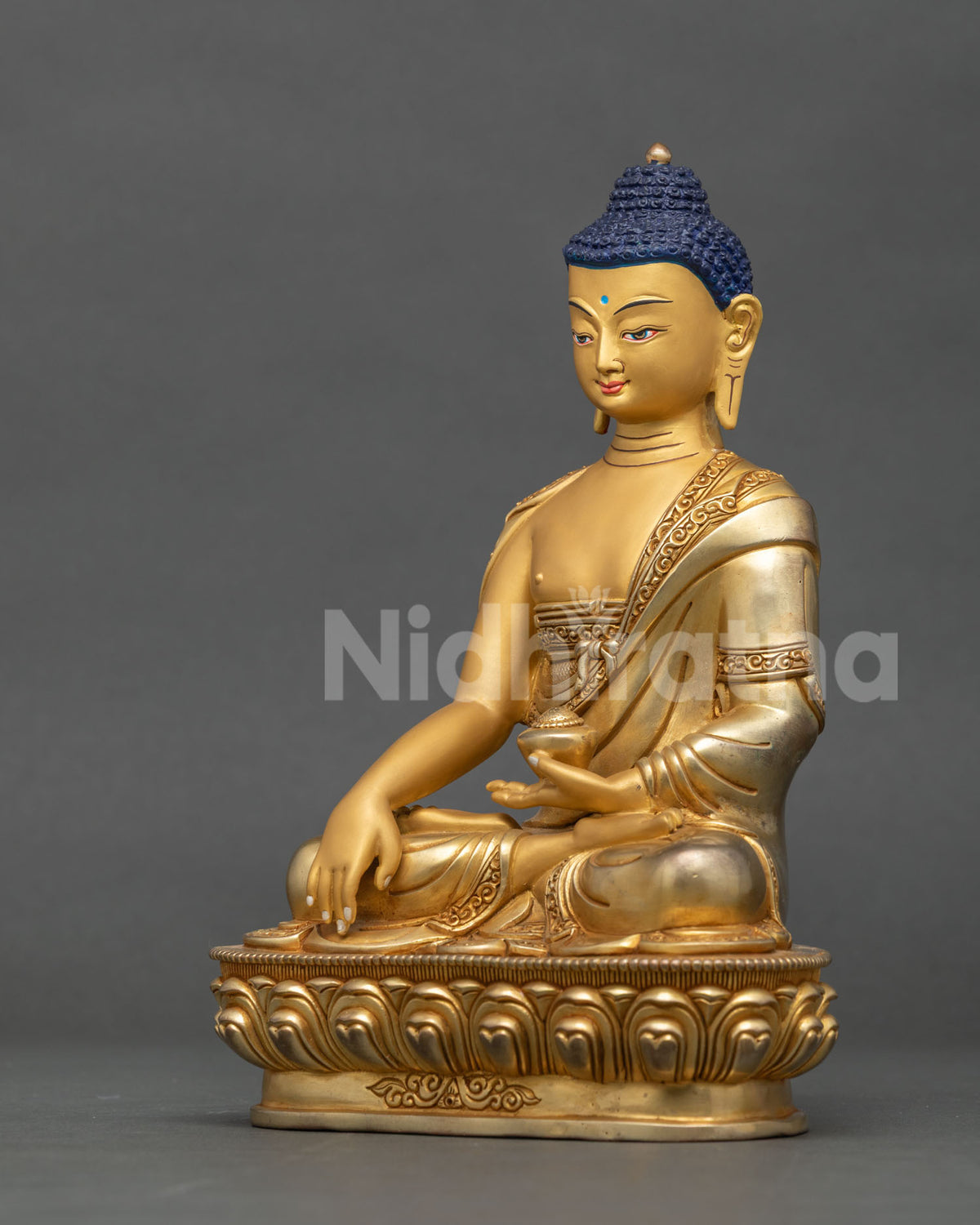 Left side view of copper Shakyamuni Buddha statue holding alms bowl, made in Patan, Nepal