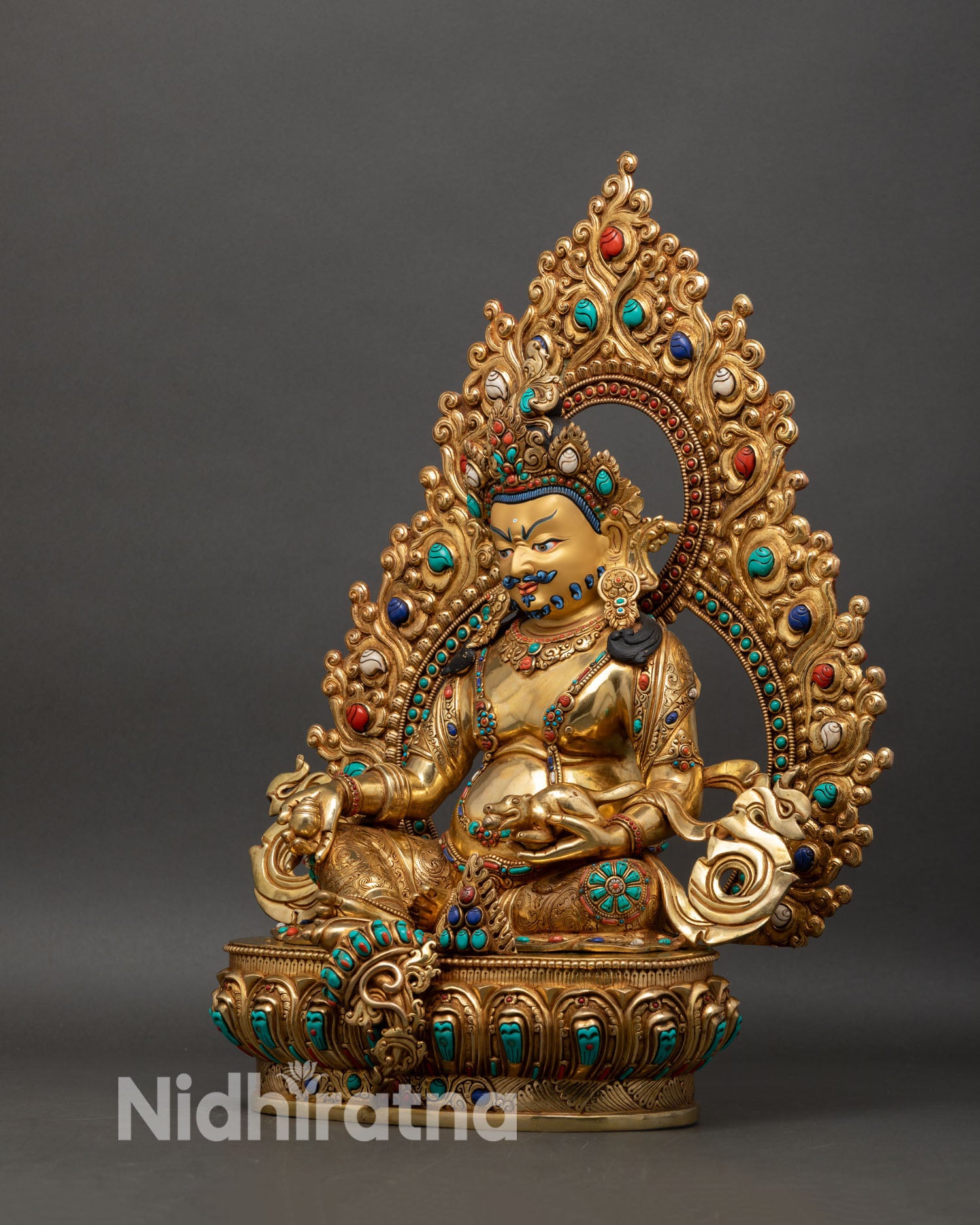 left side view of dzambhala statue with halo and rich gold fire gilding