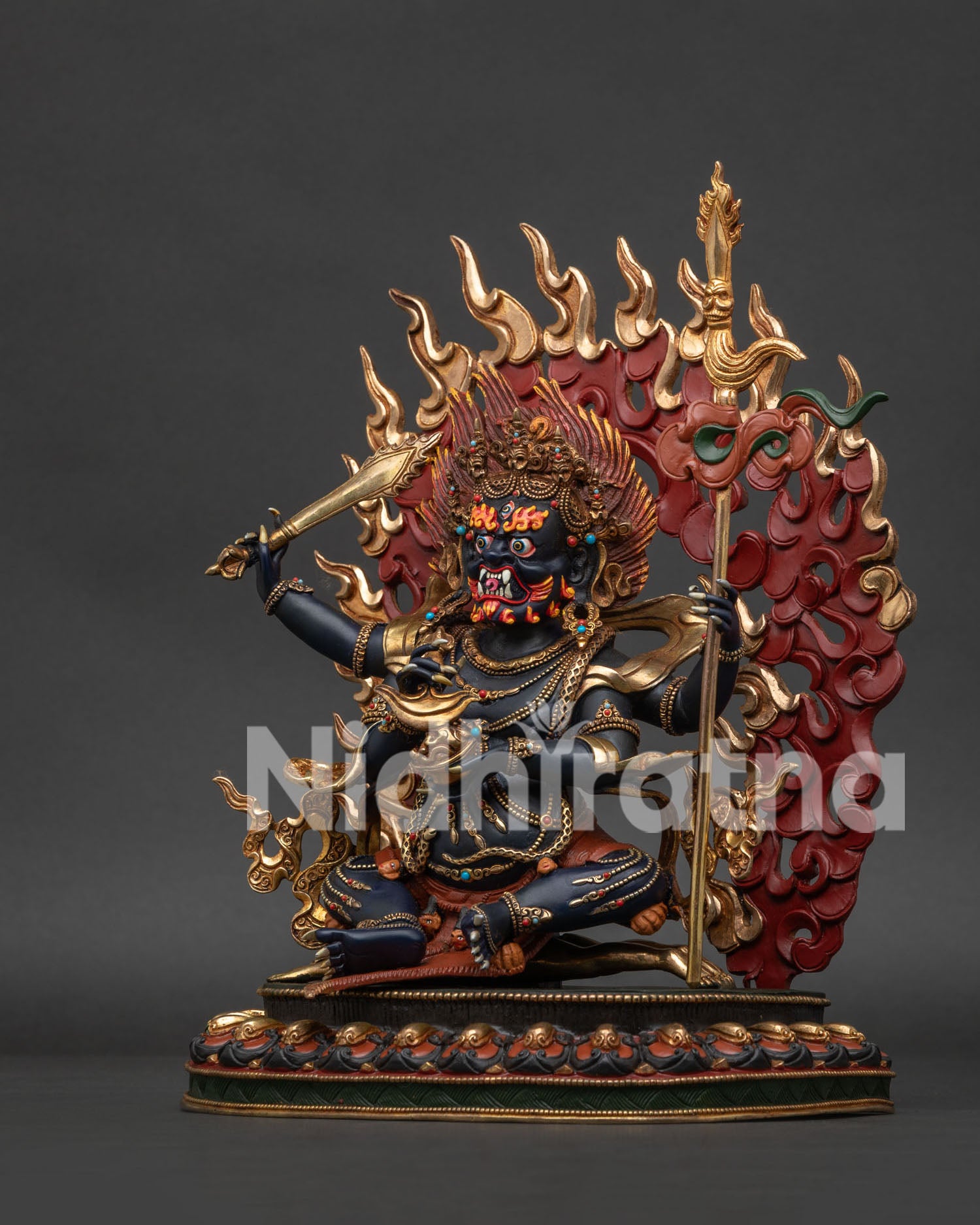 Left side view of Four Armed Mahakala statue with khatvanga staff