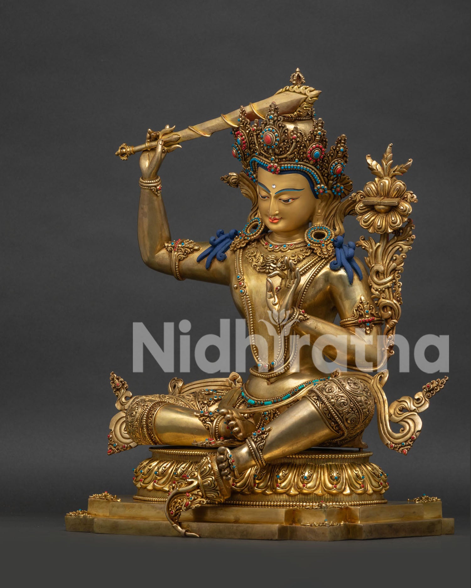 Left side view of gold-gilded Manjushri statue, handmade in Nepal