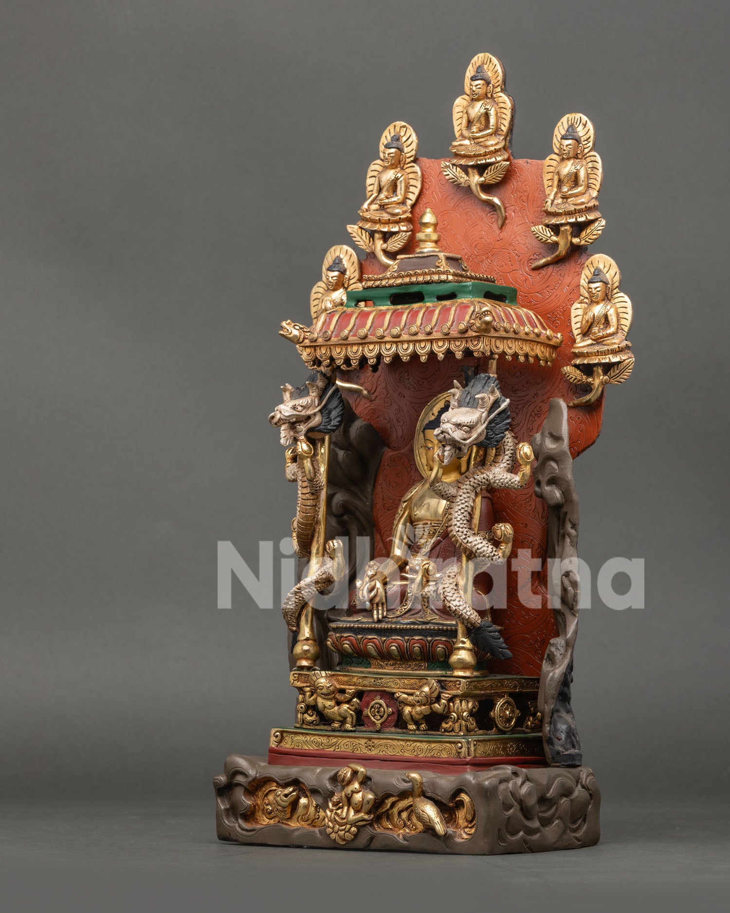 Left side view of gold-gilded Medicine Buddha statue on carved lotus pedestal