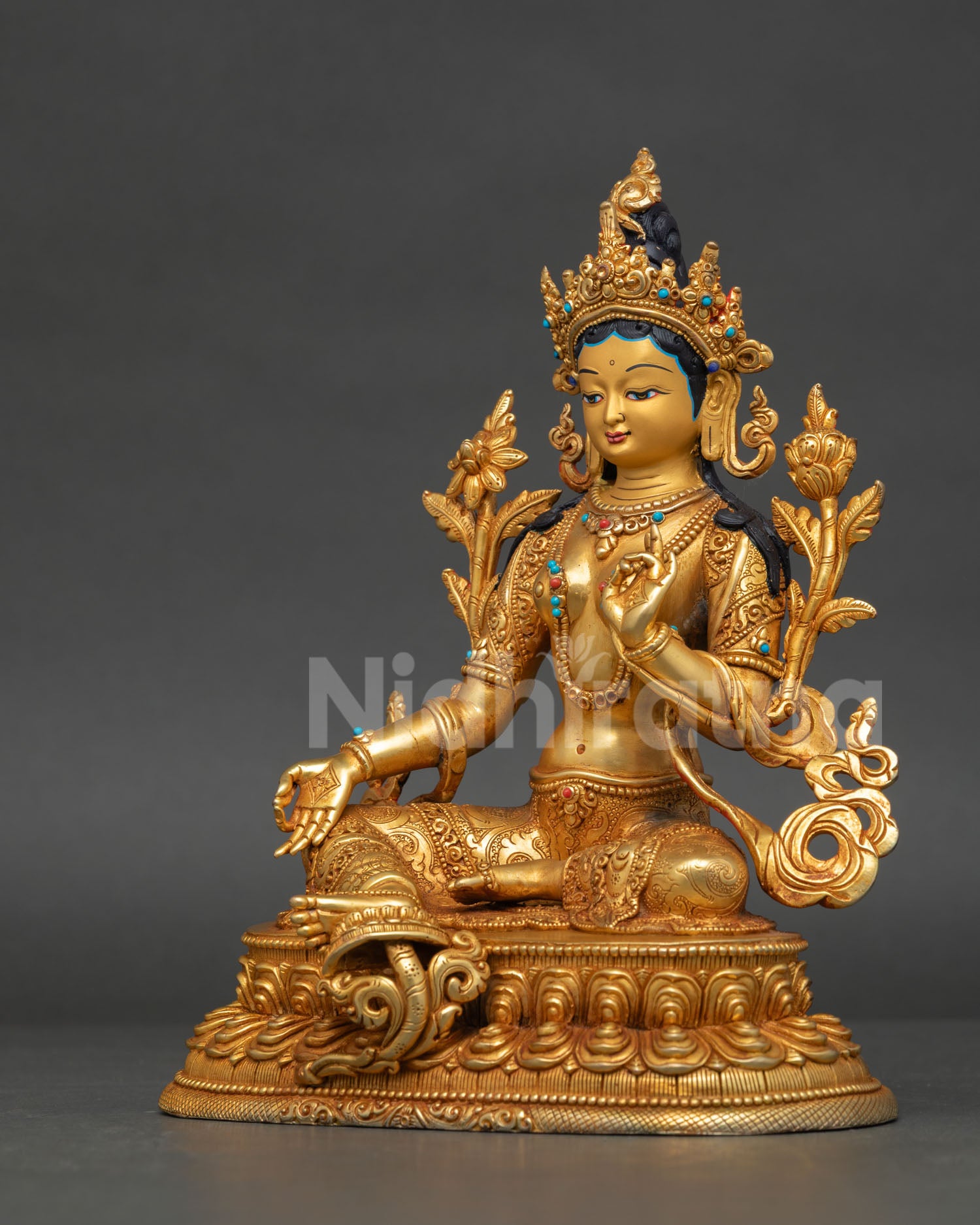 Left-side view of Green Tara Buddhist deity statue adorned with semi-precious stones