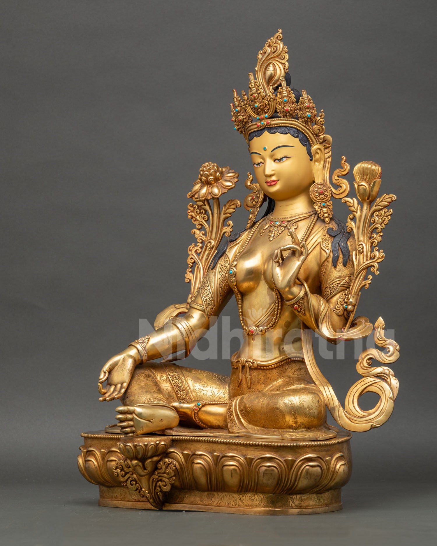 Left-side view of Green Tara Buddhist sculpture displaying royal ease posture and ornaments