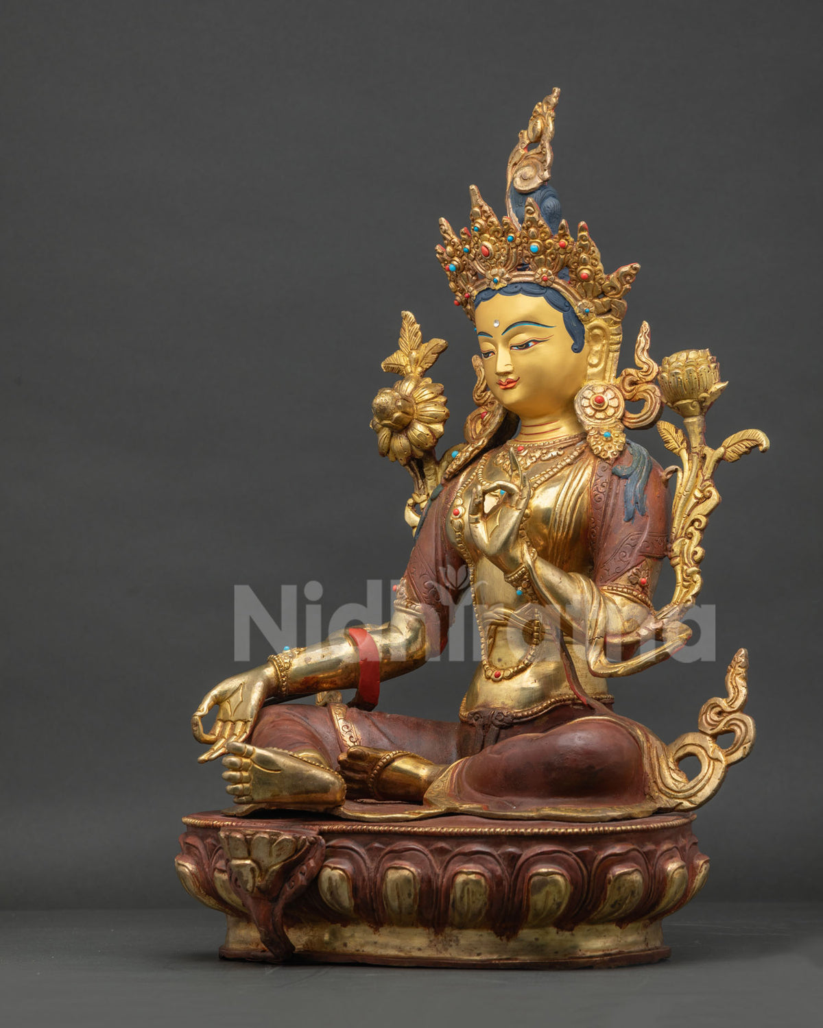 Left side view of Green Tara copper statue showing ornate robes and jewelry details
