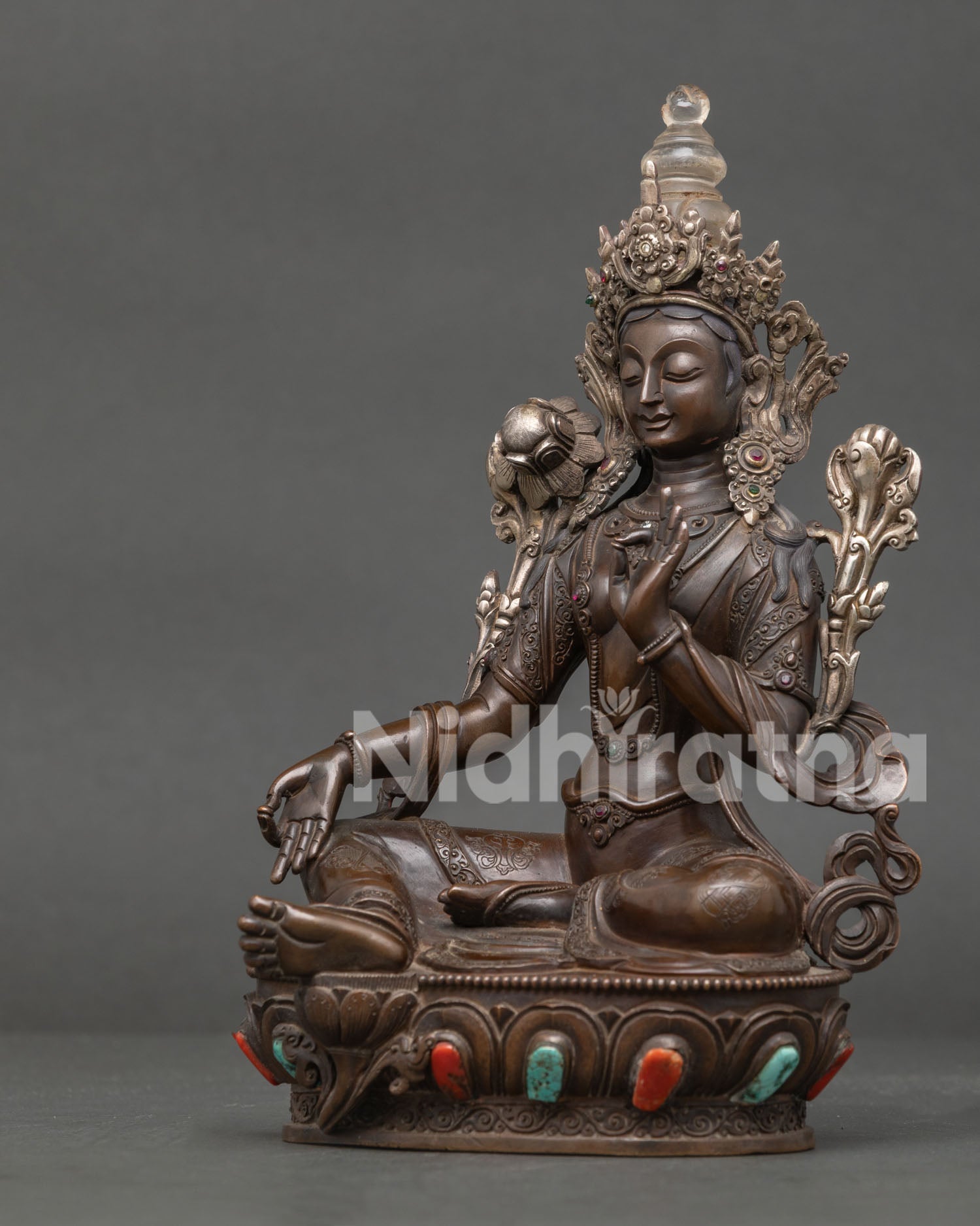 Left side view of Green Tara Statue in oxidized copper handmade in Nepal