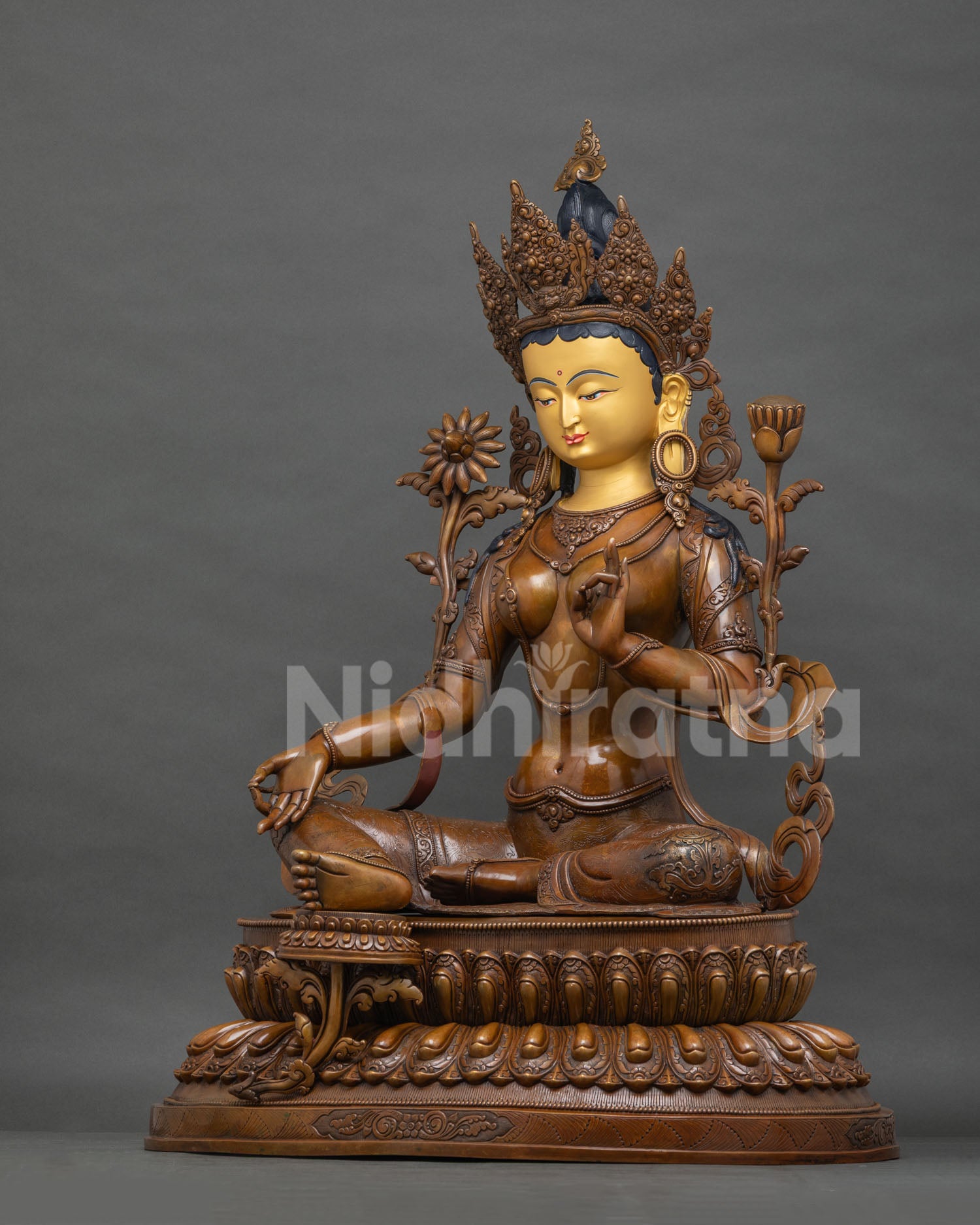 Left side view of Green Tara statue, left hand in abhaya mudra, gesture of protection
