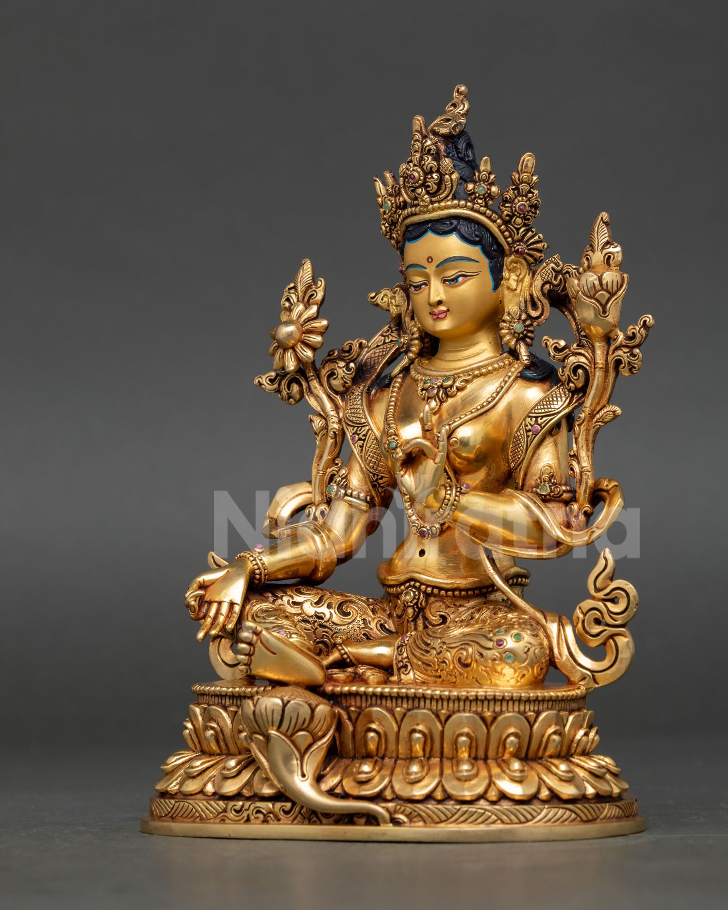 left side view of green tara statue showing flowing robes and detailed Himalayan metal craftsmanship