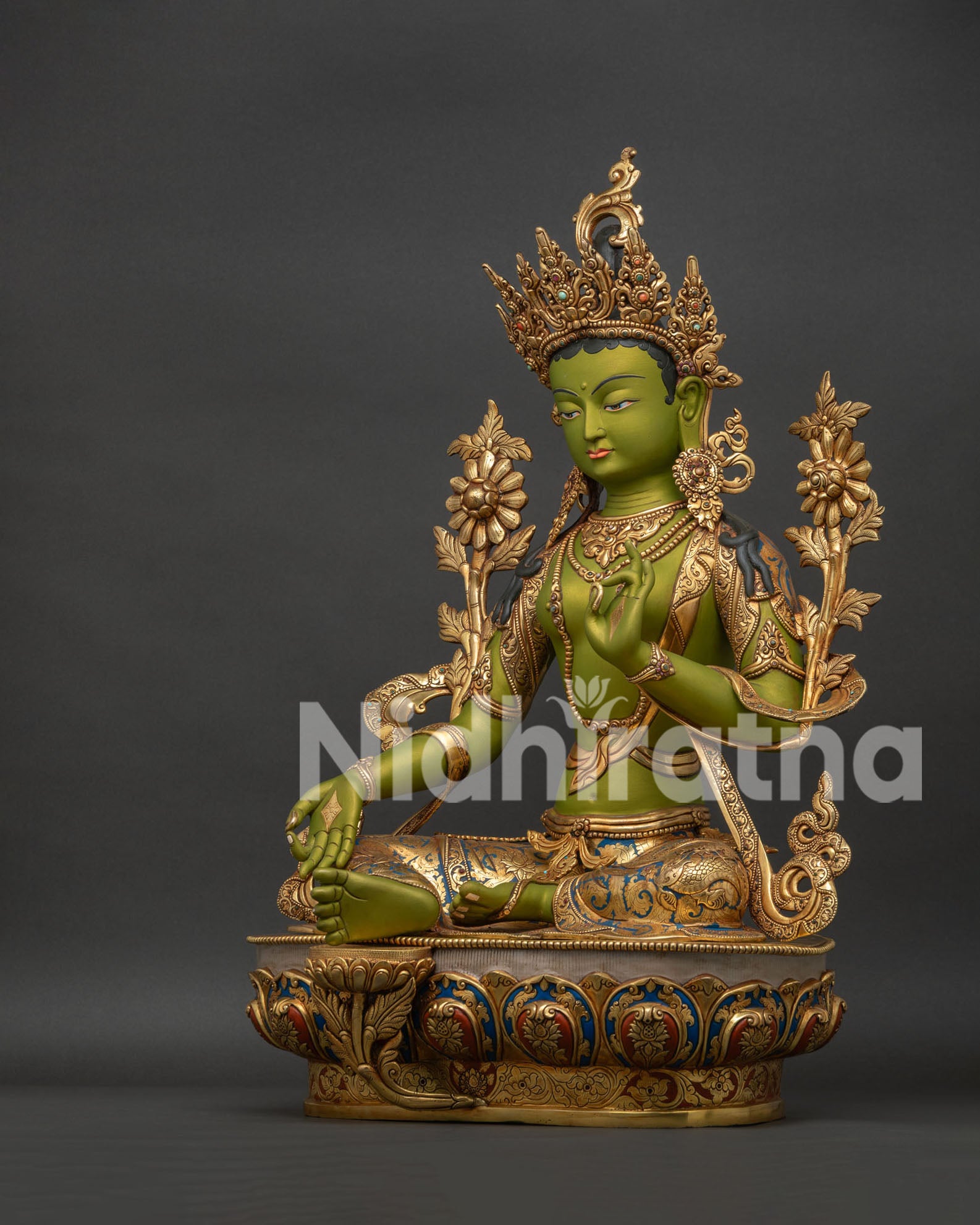 Left side view of Green Tara statue showing gold gilding lotus flowers and ornate jewelry