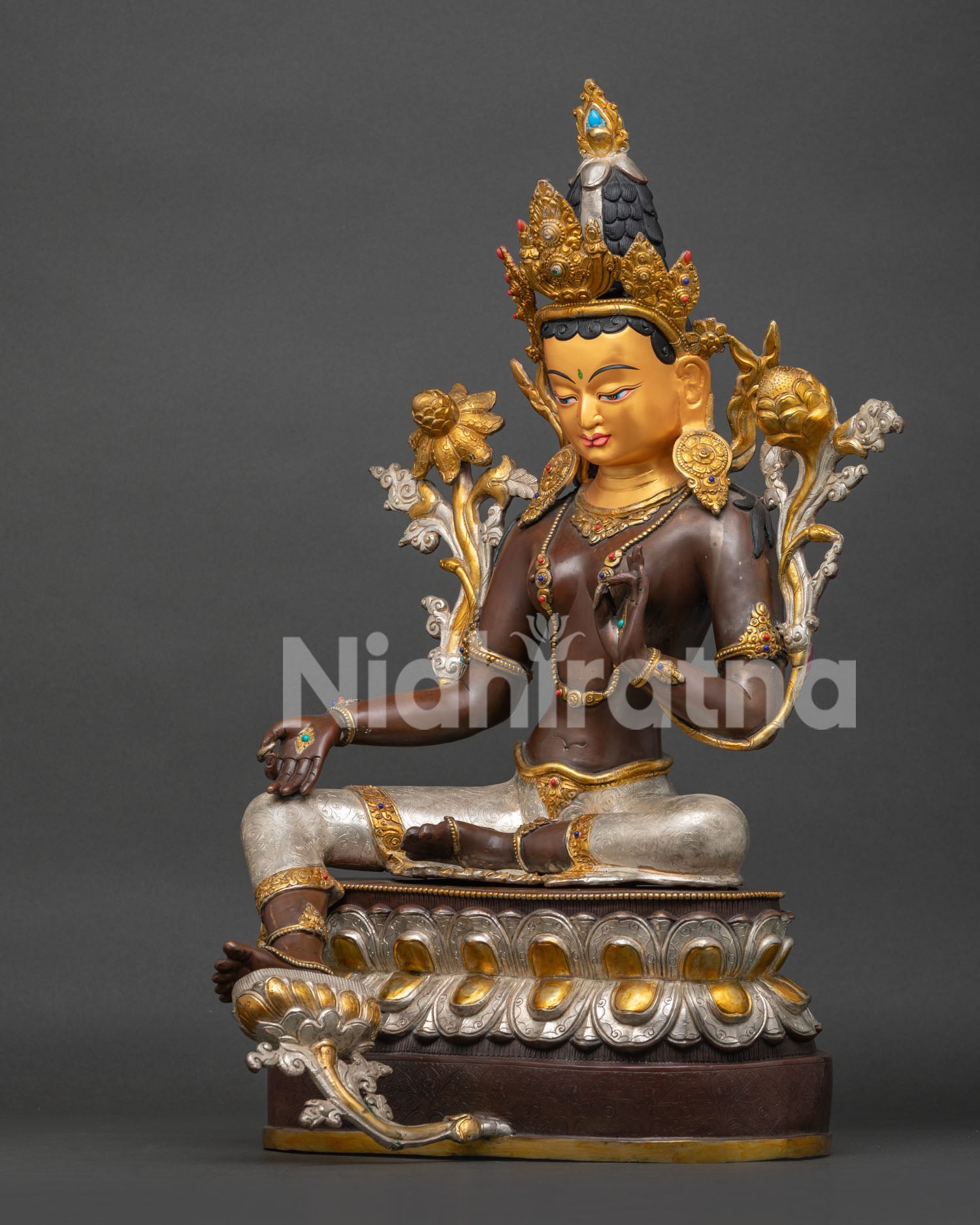 Left side view of Green Tara statue showing lotus throne detailing