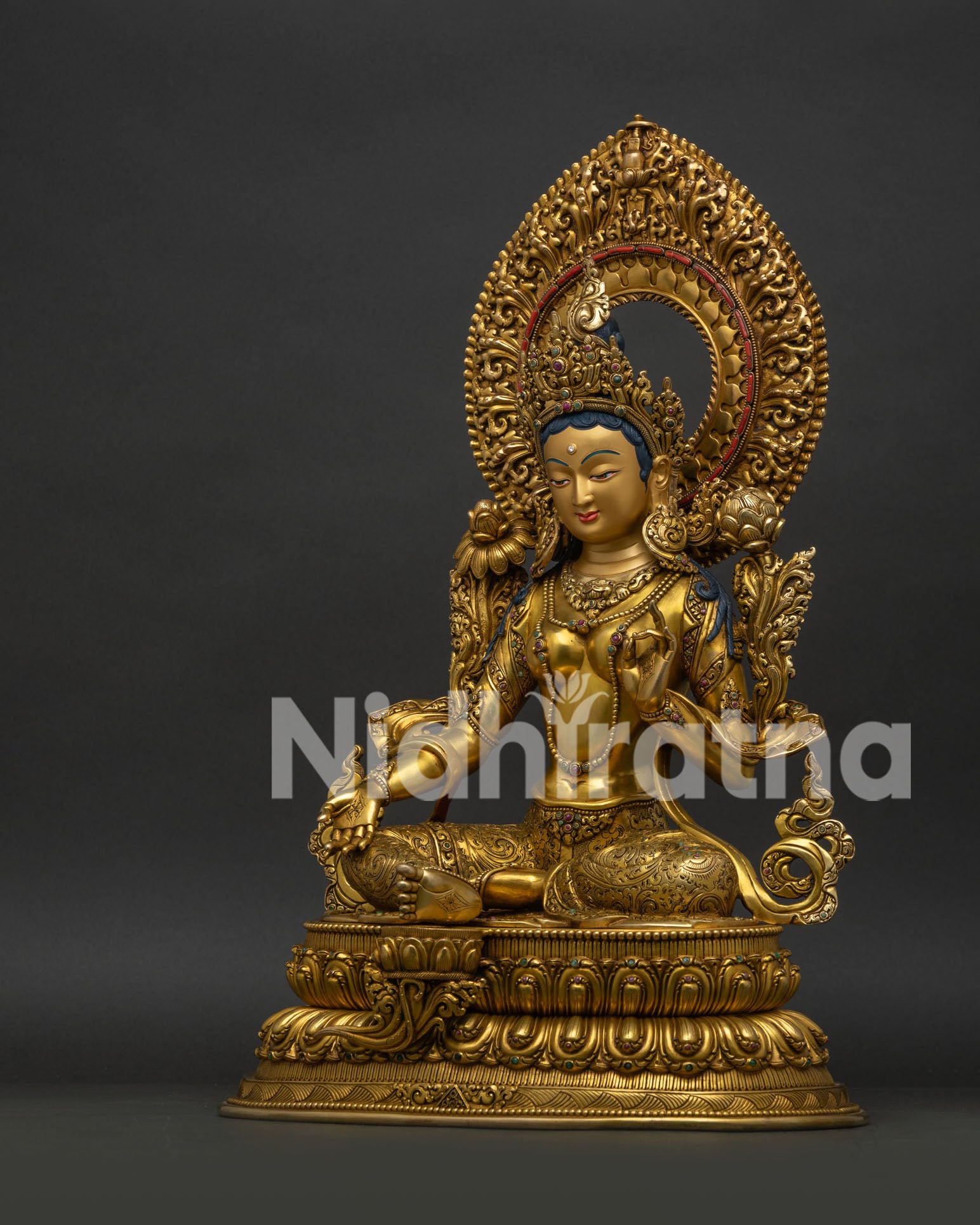 Left side view of Green Tara Statue with lotus throne and fire gilded craftsmanship
