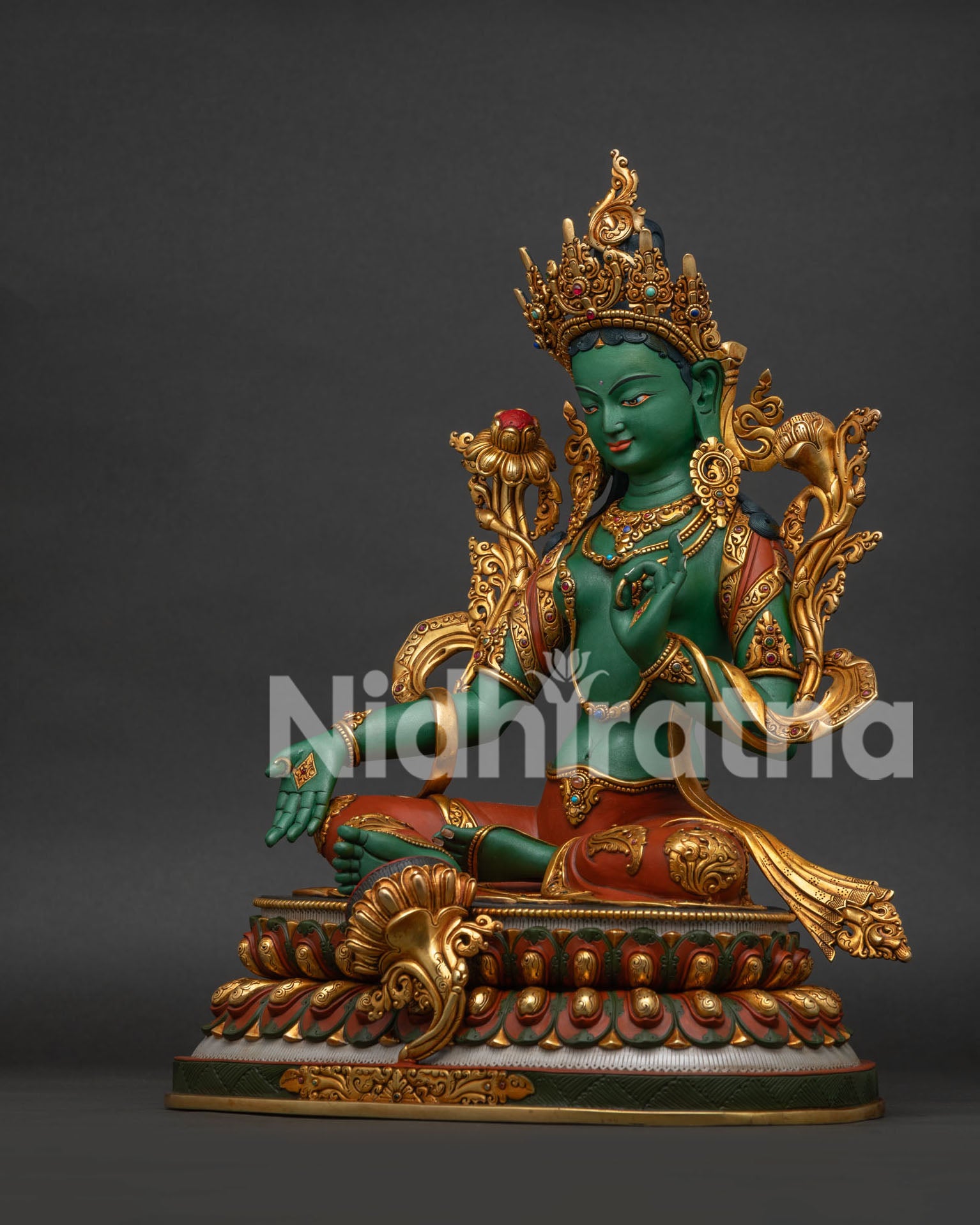 Left side view of hand-painted Green Tara statue showing Vitarka Mudra pose
