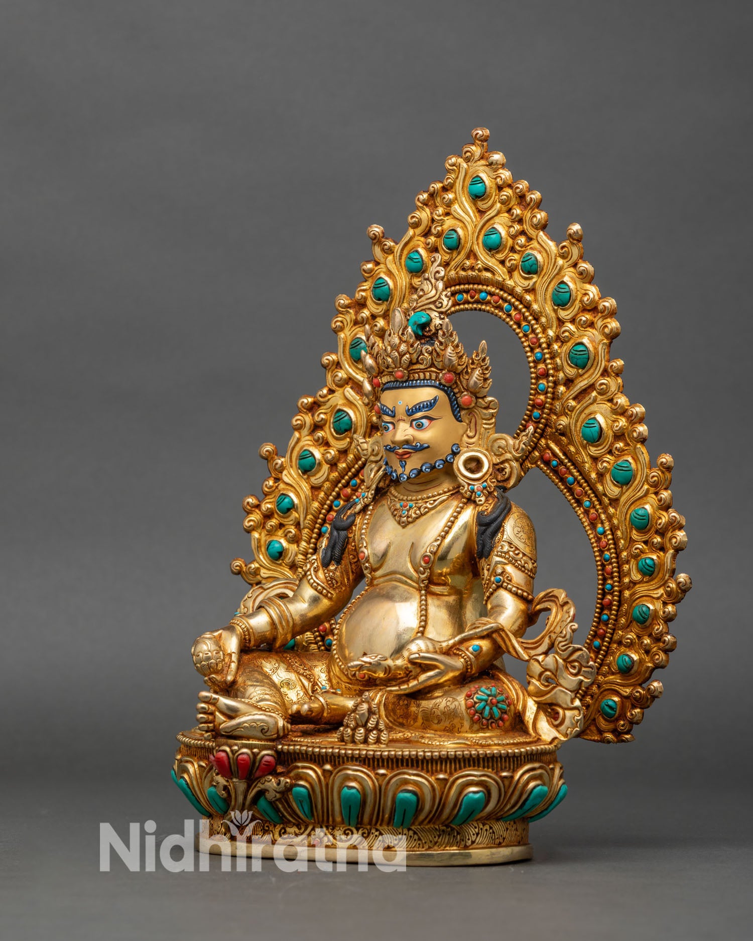 Right side view of Dzambhala wealth deity statue seated on lotus base with mongoose