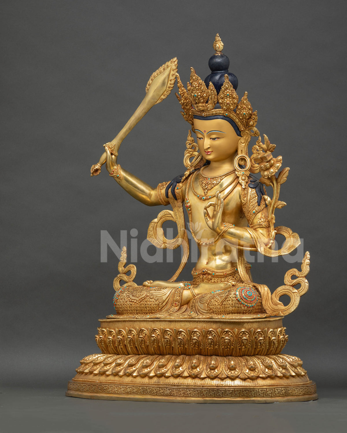 Left side view of handcrafted Manjushri statue with lotus pedestal, Nepal