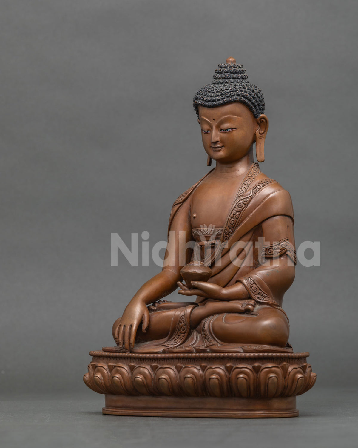 Left side view of handcrafted Shakyamuni Buddha statue with brown patina, Newari copper art