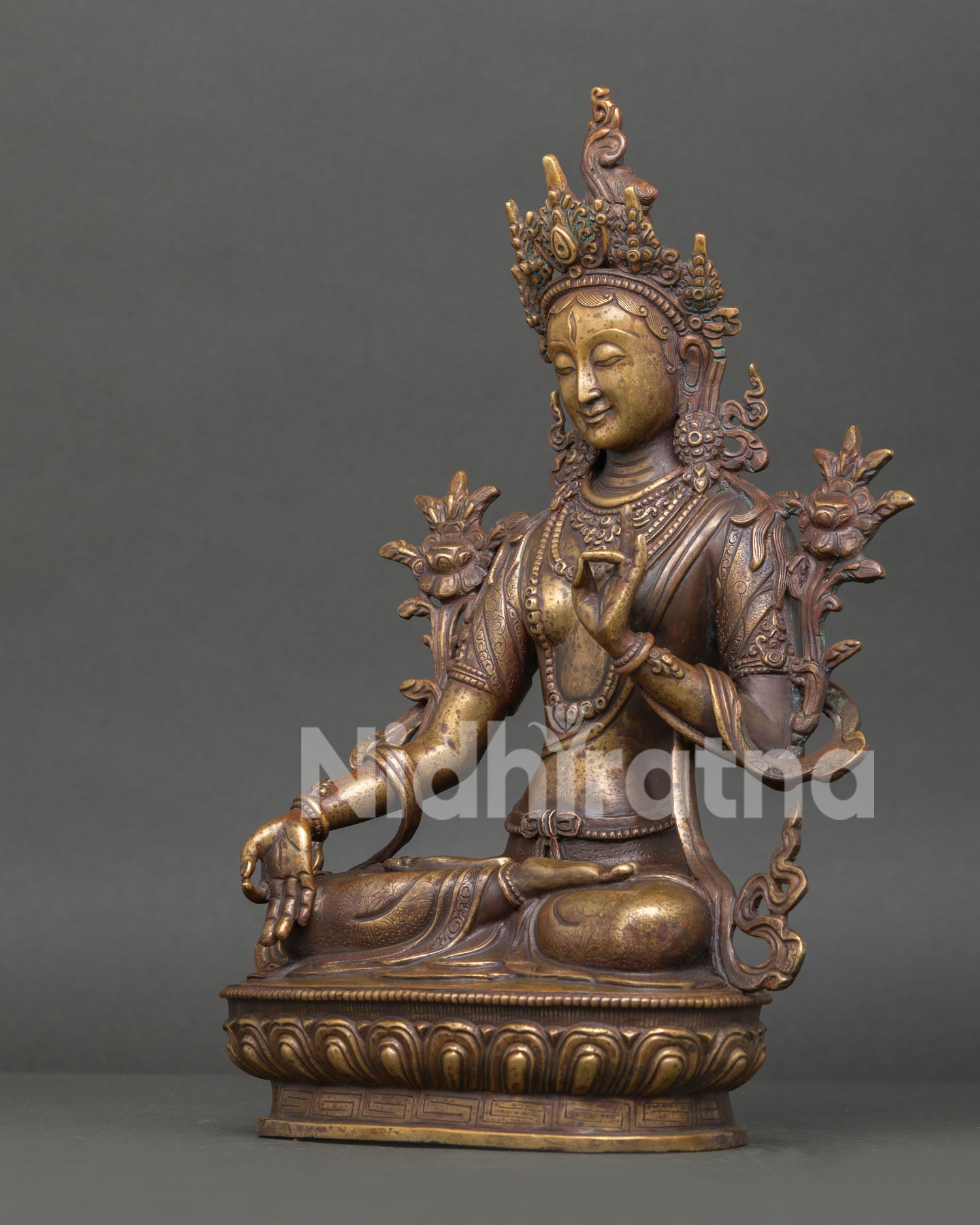 Left side view of handcrafted White Tara copper statue with detailed Buddhist artwork