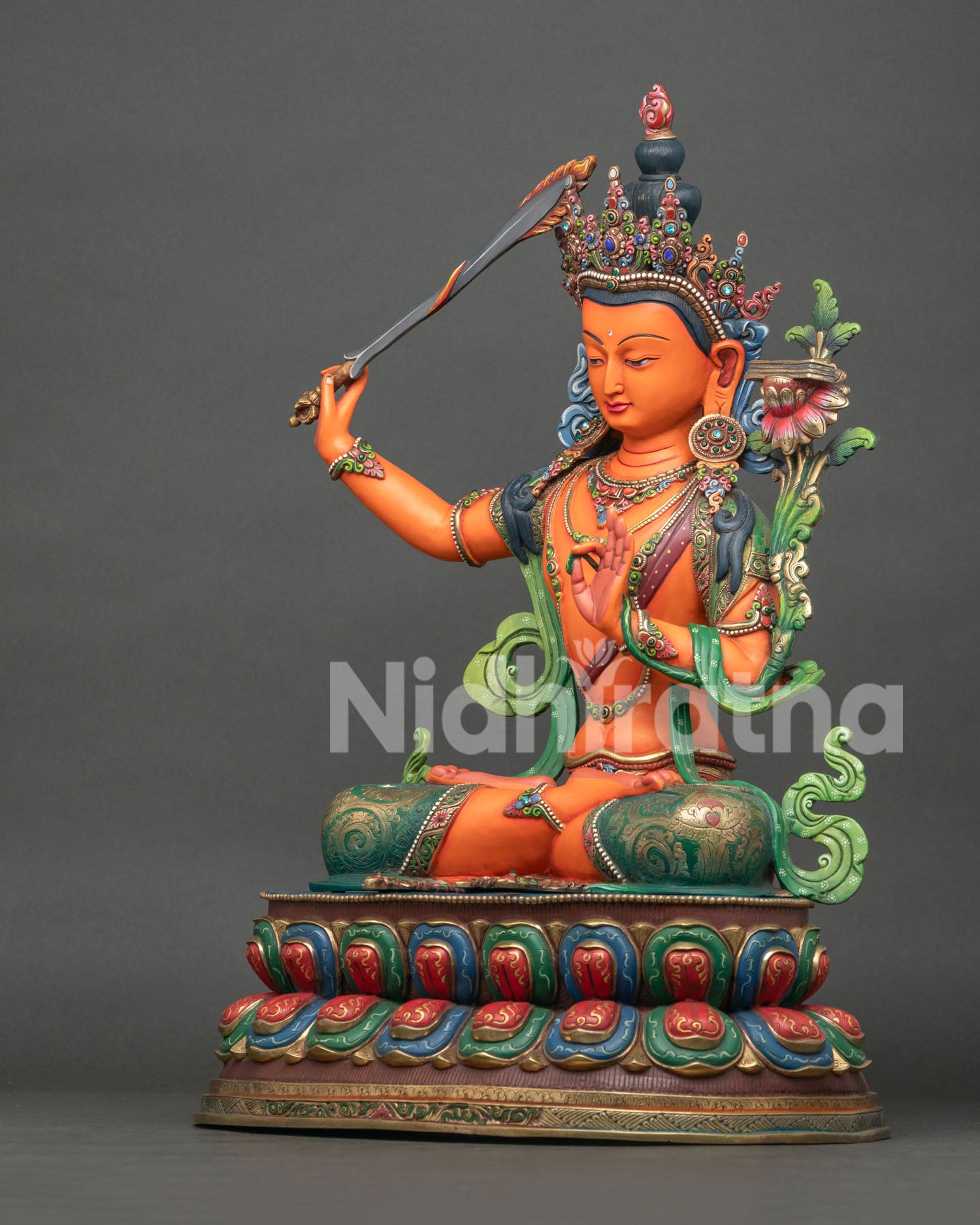 Left side view of handmade Manjushri statue with Prajnaparamita lotus support