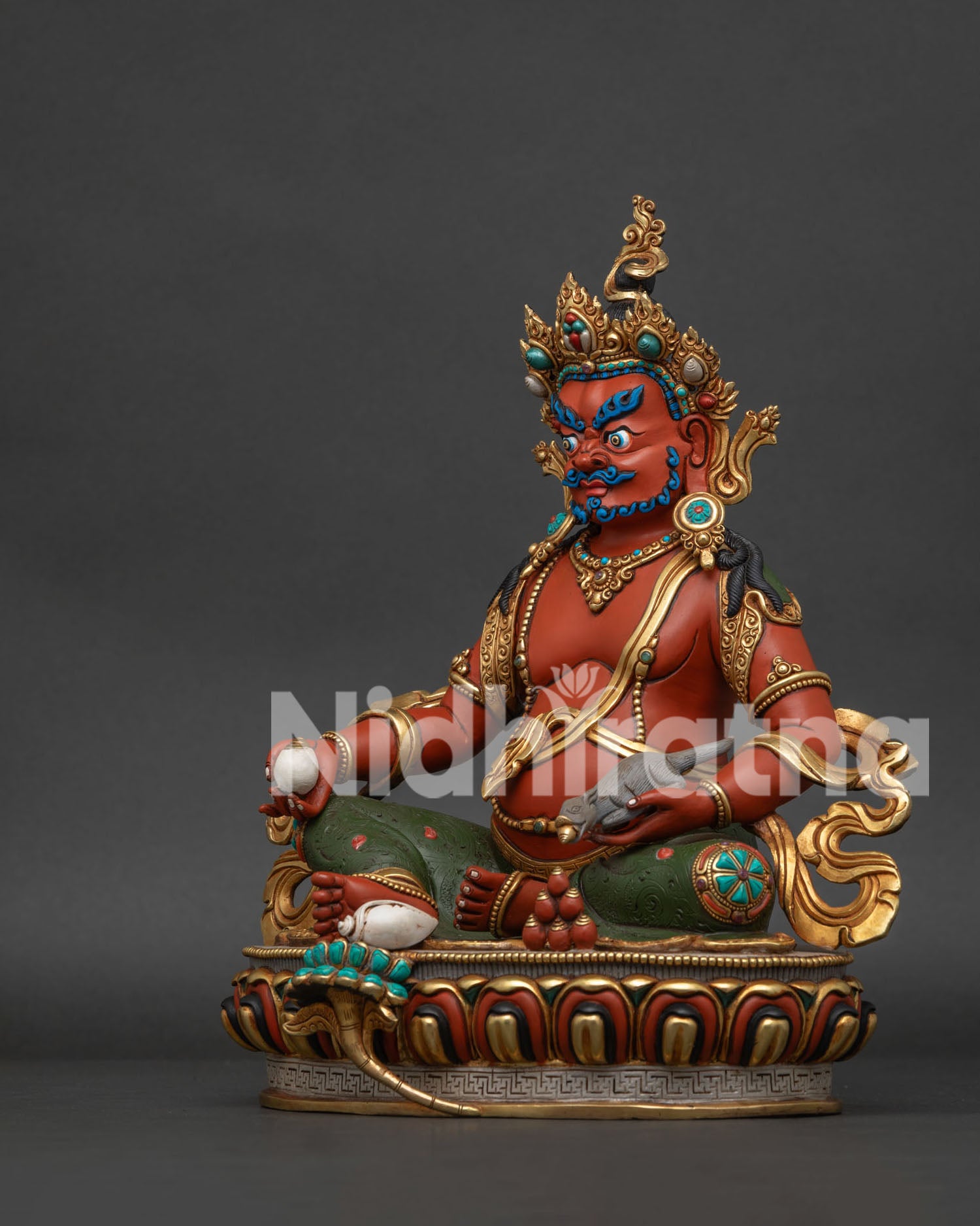 Left side view of Jambhala statue displaying the sacred jewel-spewing mongoose and turquoise inlays.
